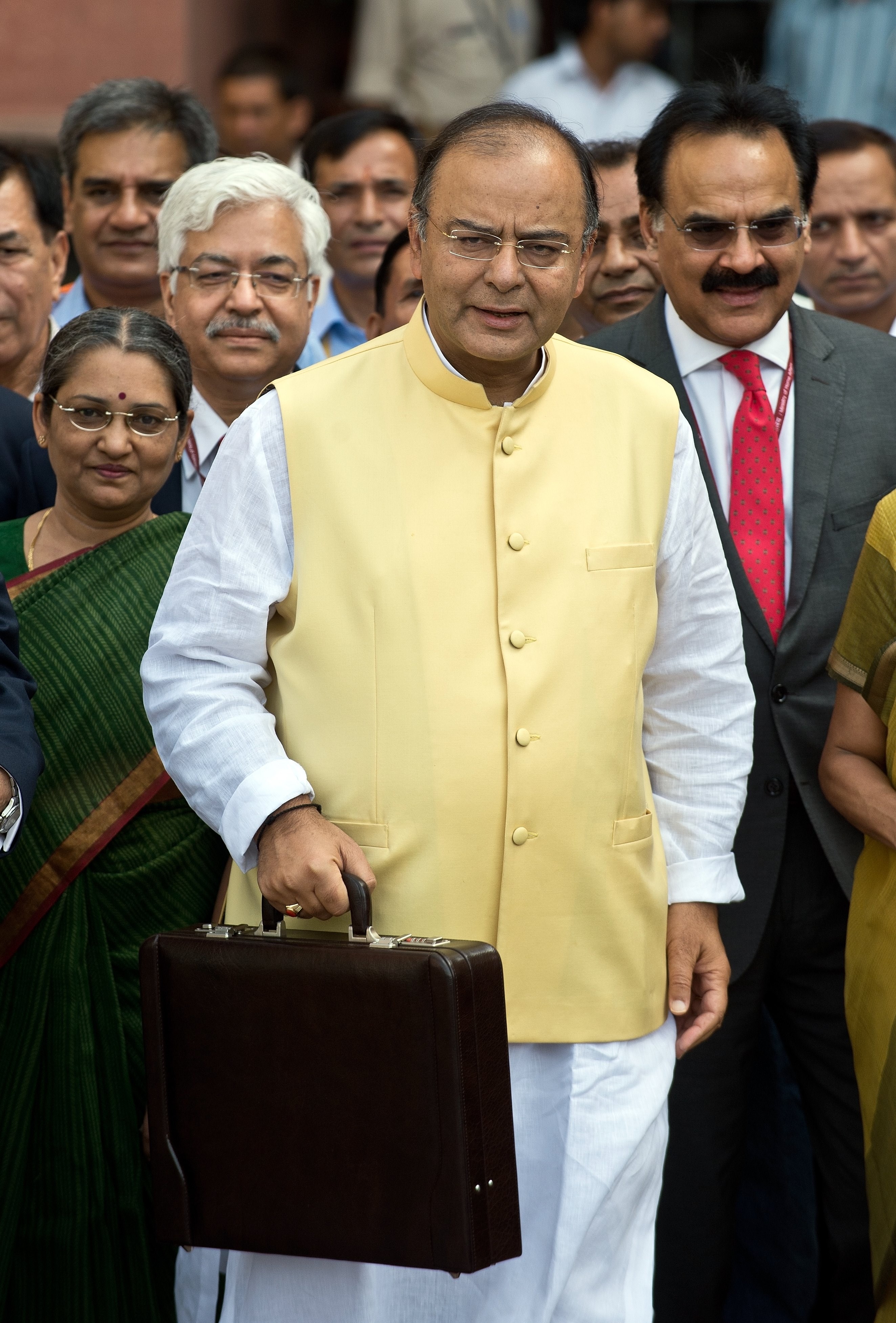 Indian Finance Minister Arun Jaitley, center, leaves his office to table the budget in Parliament in New Delhi on July 10, 2014 (PRAKASH SINGH—AFP/Getty Images)