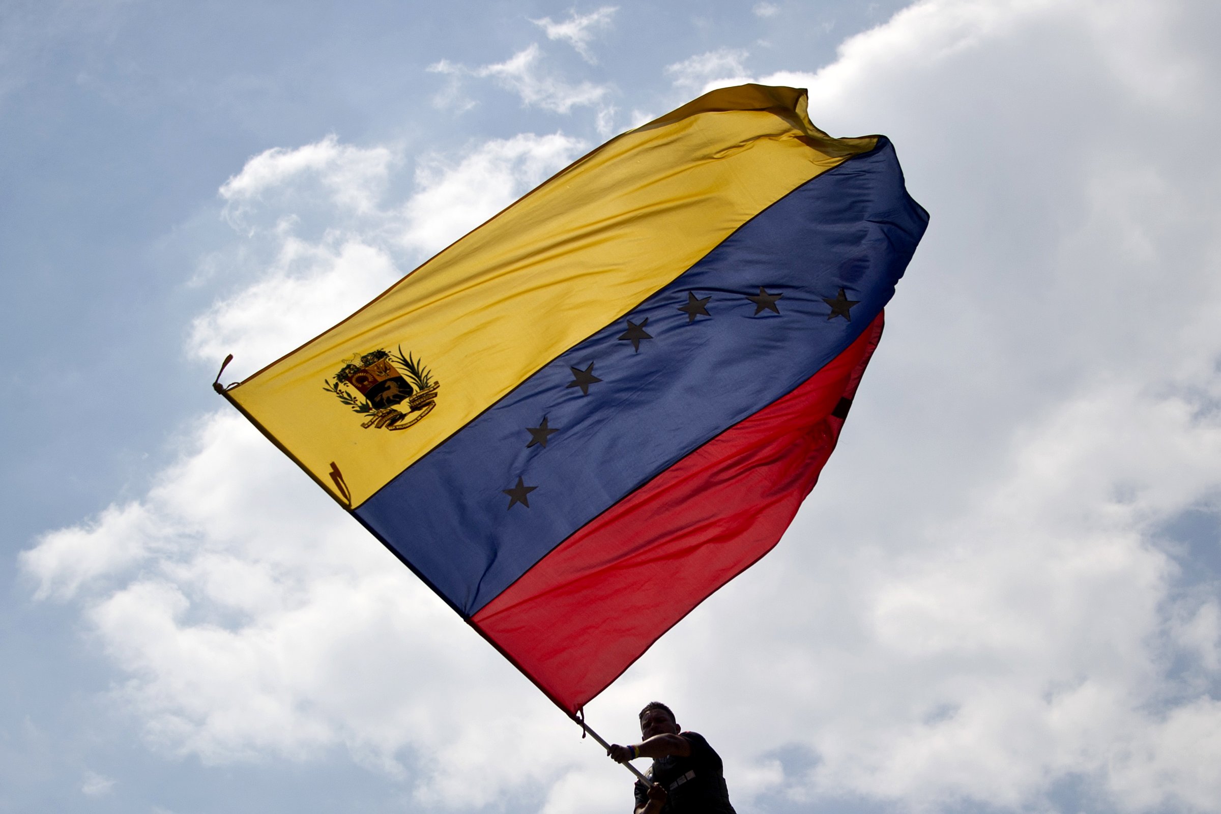 A man waves a Venezuelan flag during a protest against the government of President Nicolas Maduro in San Cristobal, Venezuela, on Feb. 22, 2014.