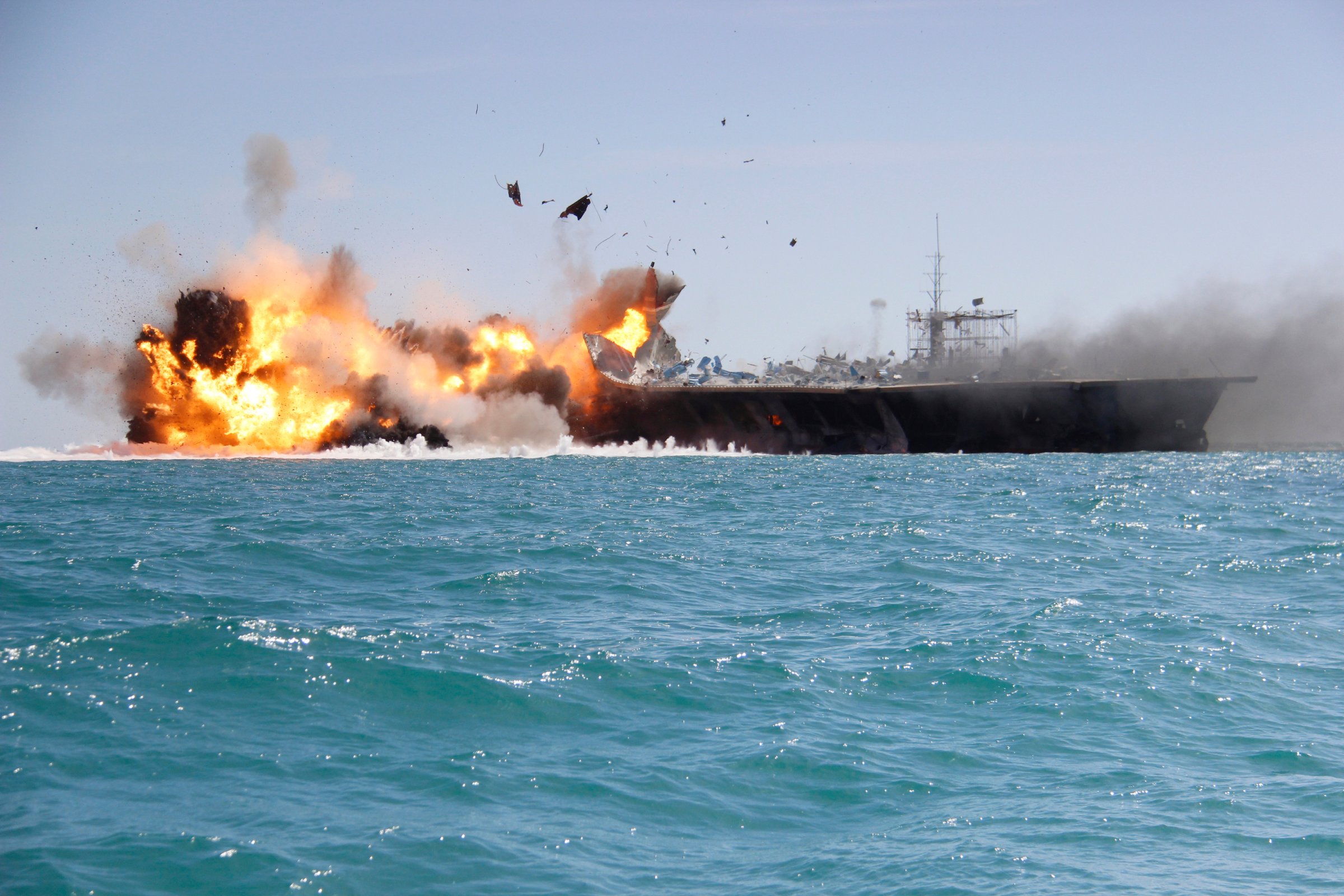 A replica of a U.S. aircraft carrier is exploded by the Revolutionary Guard during naval drills near the entrance of the Persian Gulf, Iran on Feb. 25, 2015.
