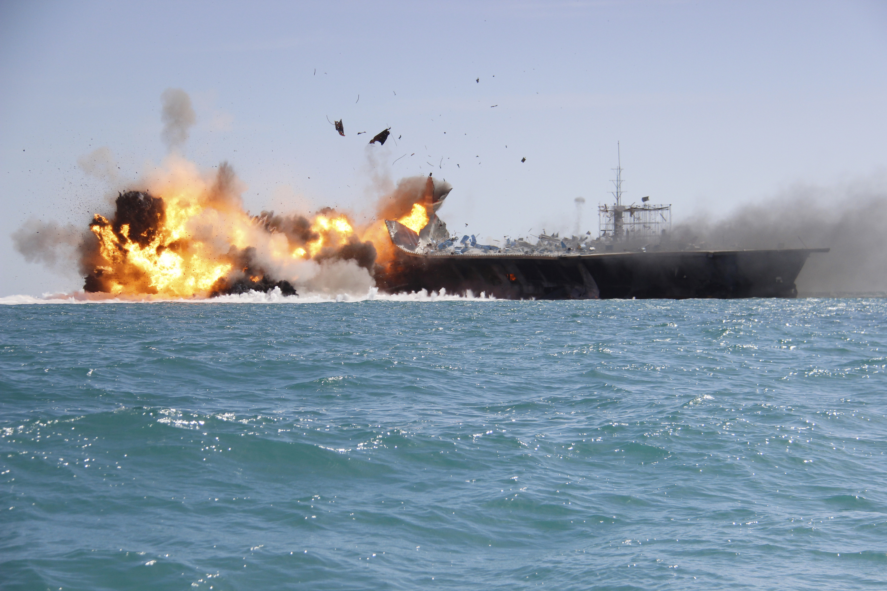 A replica of a U.S. aircraft carrier is exploded by the Revolutionary Guard during naval drills near the entrance of the Persian Gulf, Iran on Feb. 25, 2015. (Iranian Tasnim News Agency/AP)