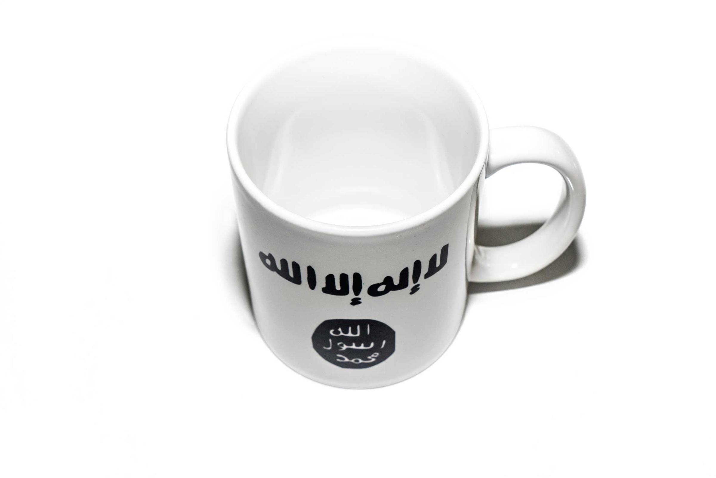 Items of clothing and objects found in a Islamic clothing and accessory shop in the Bagicilar district of Istanbul. A western style tea mug with the icopnography of Islamic State on the side.