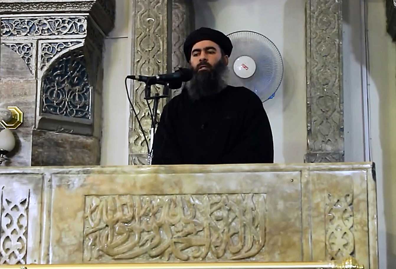 ISIS leader Abu Bakr al-Baghdadi, seen in this video screengrab, at the mosque in Mosul in 2014. (Anadolu Agency/Getty Images)