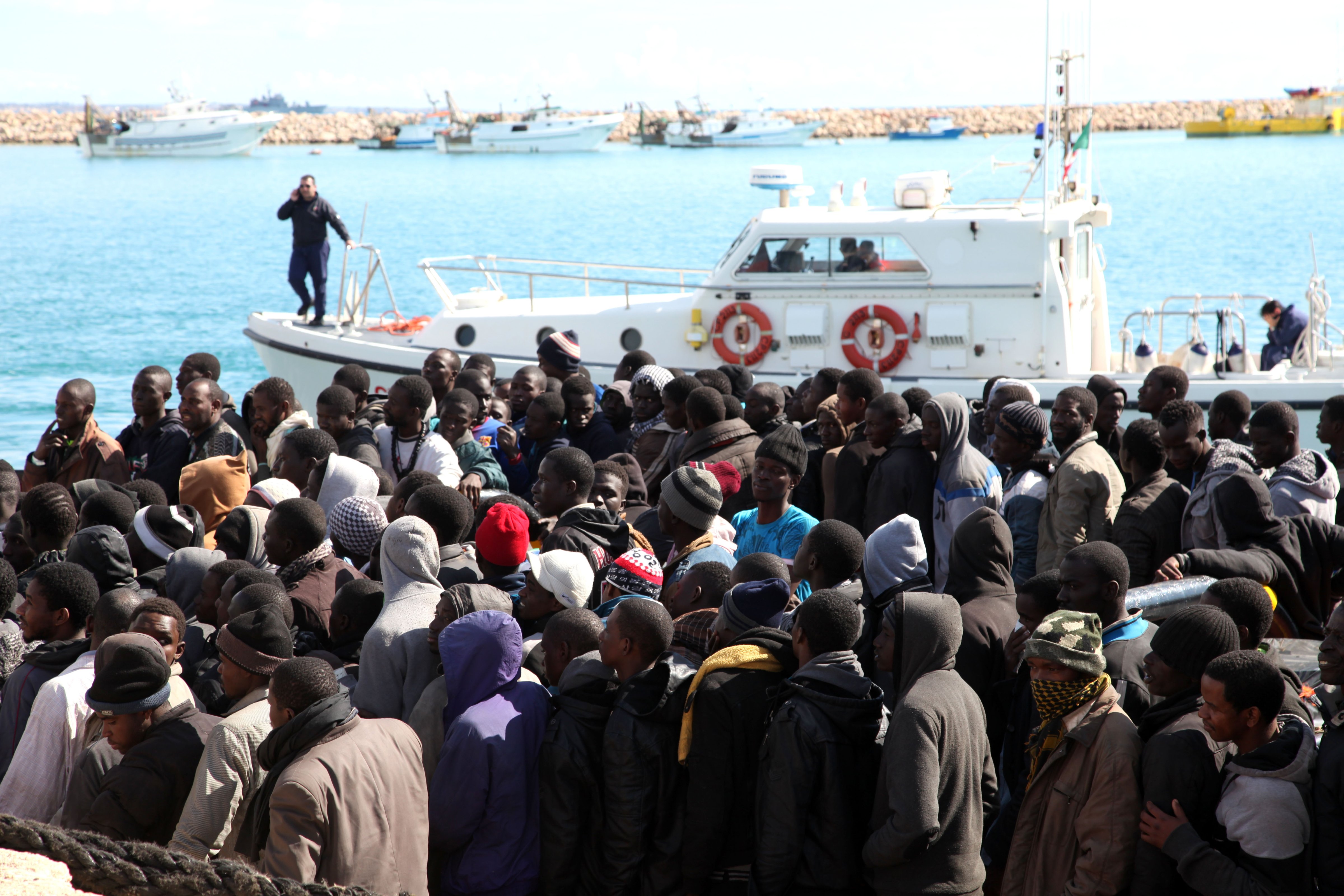 Migrants wait to disembark from a tugboat after being rescued in the Pozzallo harbor in Sicily, Italy, on Feb. 15, 2015 (Francesco Malavolta—AP)