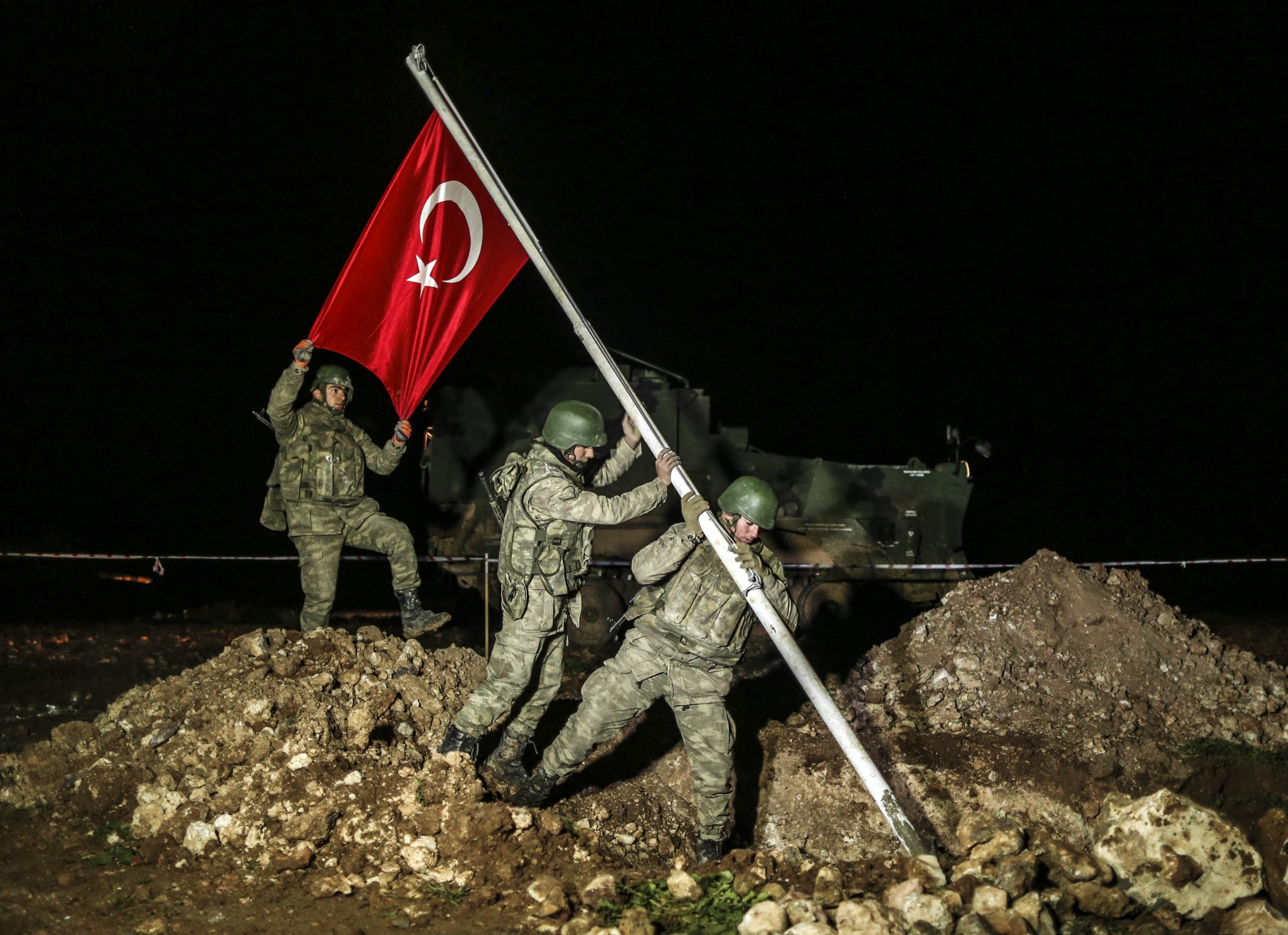 Turkish soldiers put a wire fence around area after Turkish flag is raised on Feb. 22, 2015 in the Esme region of Aleppo where the Tomb of Suleyman Shah will be placed.