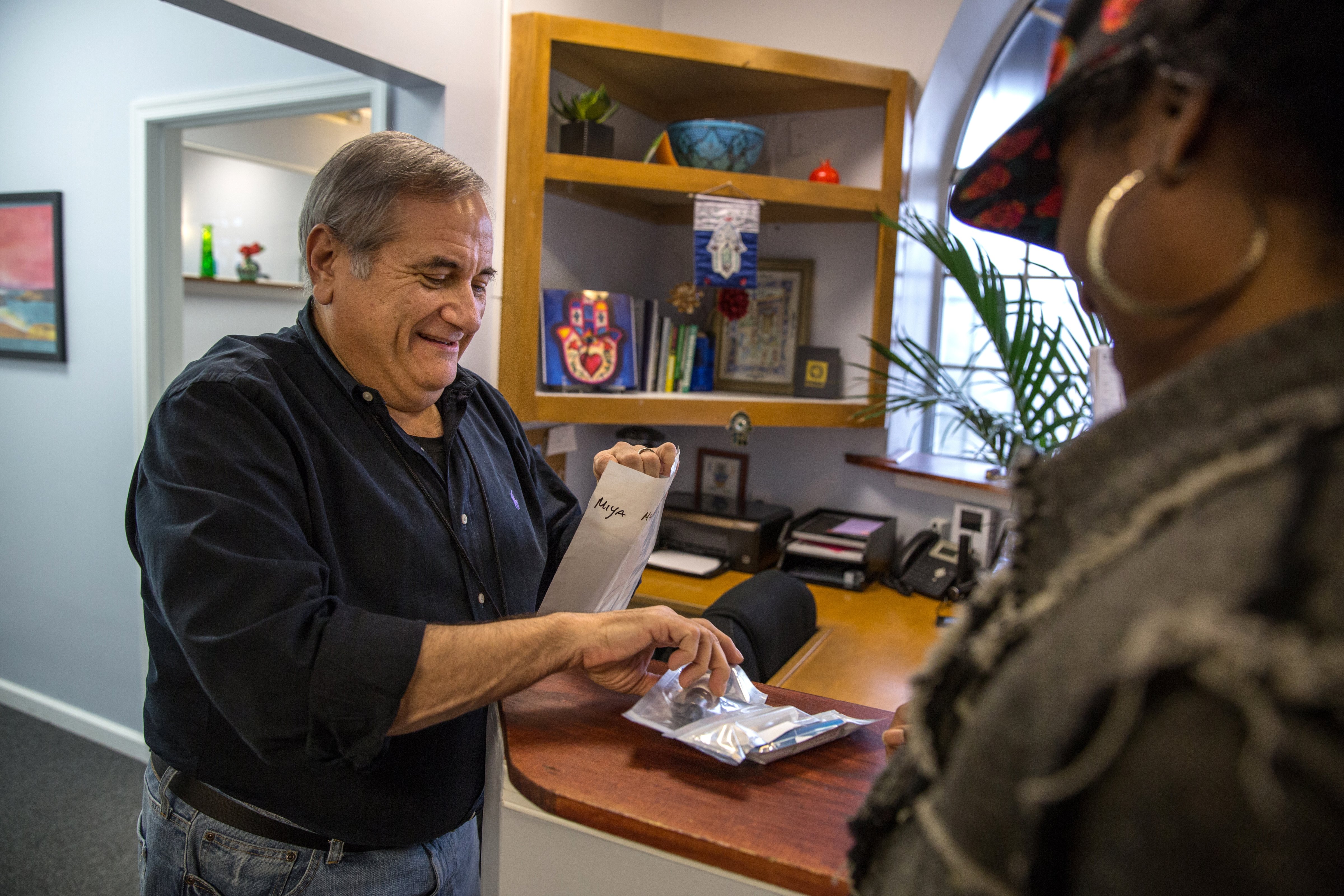 Rabbi Jeffrey Kahn, owner of the Takoma Wellness Center, dispenses medical marijuana on Oct. 10, 2014, in Takoma Park, DC.