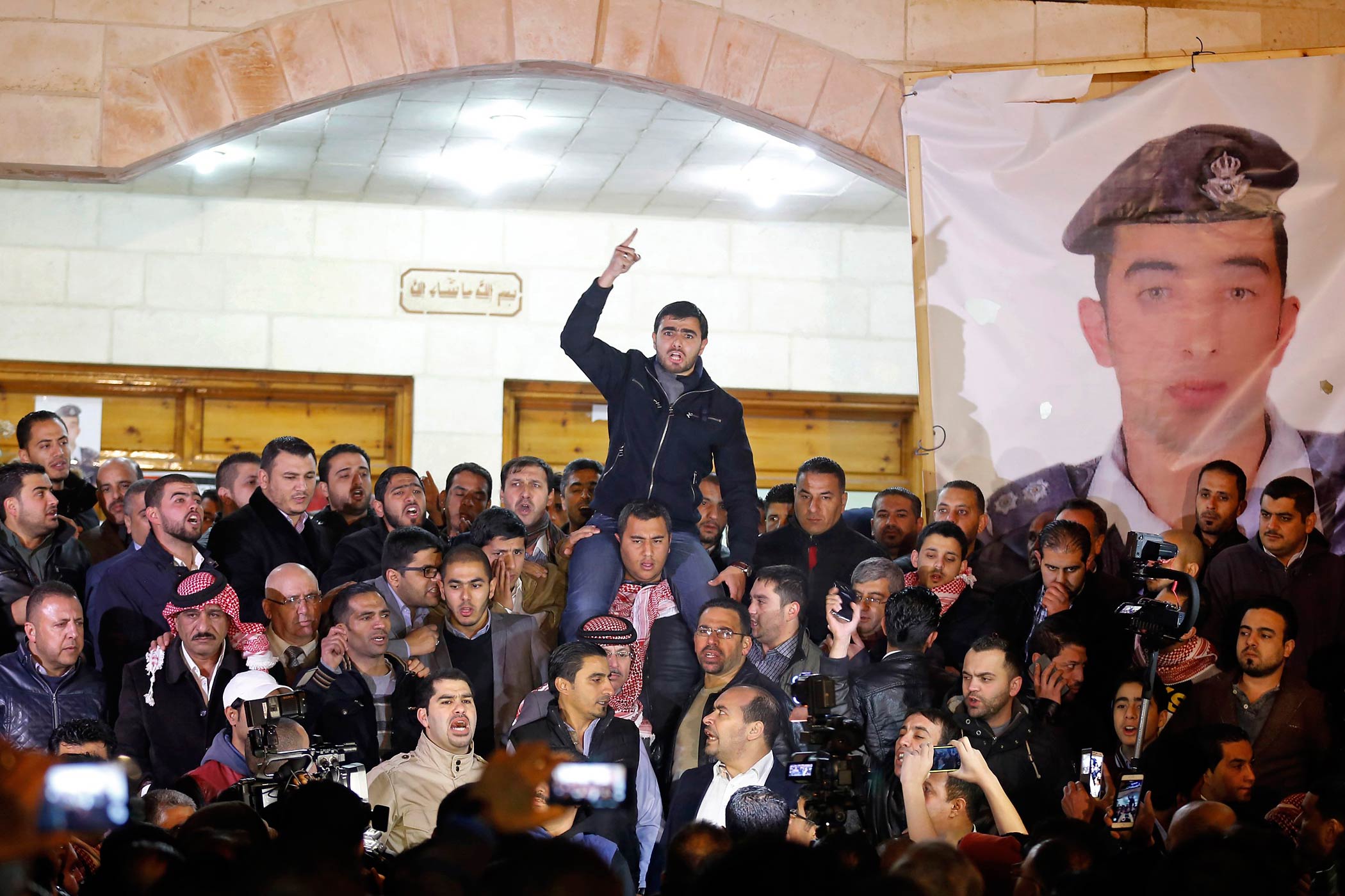 Supporters and family members of Jordanian pilot Moaz al-Kasasbeh at the tribal gathering chamber in Amman, Jordan, express their anger at his reported killing on Feb. 3, 2015 (Raad Adayleh—AP)