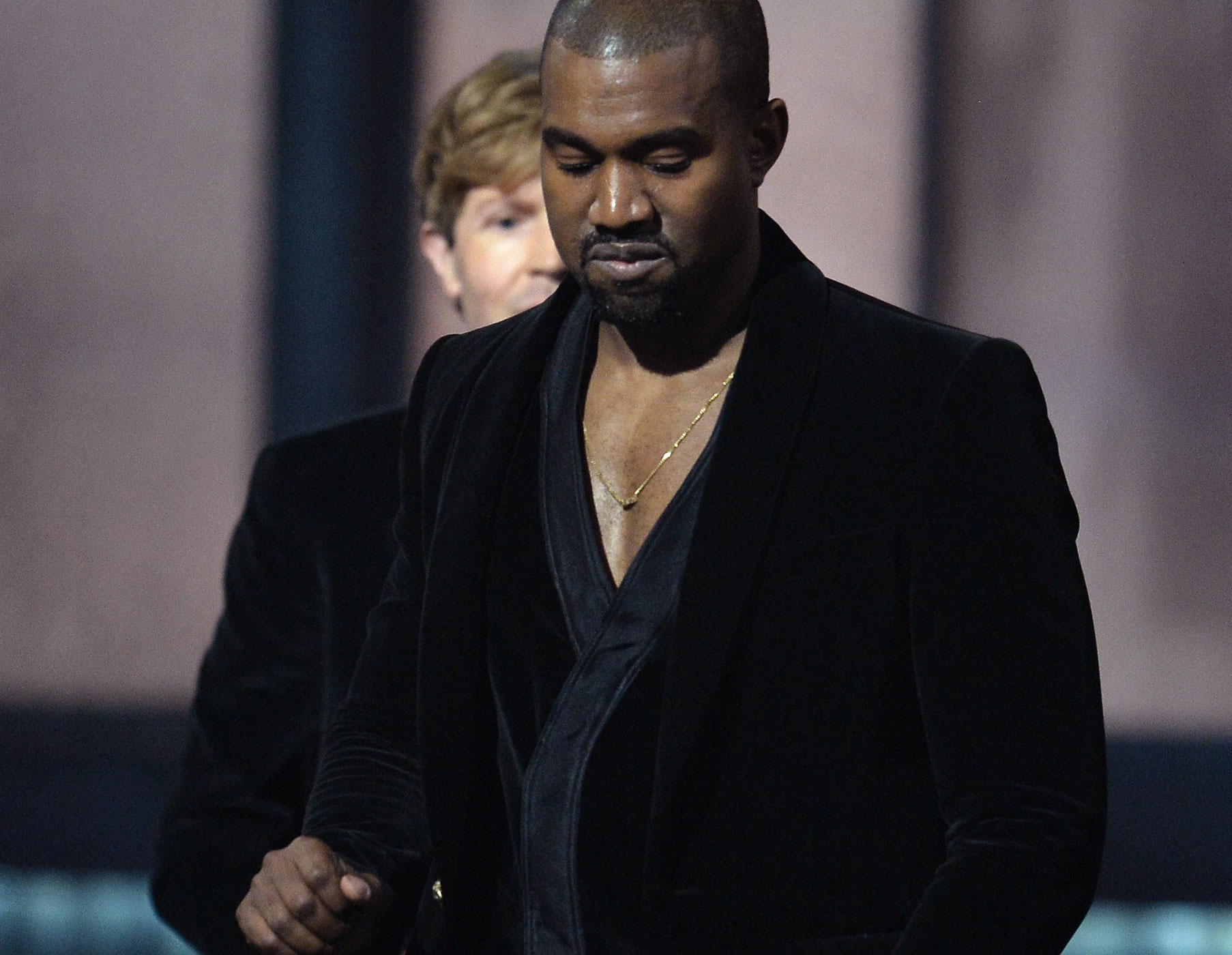 Winner for Album Of The Year Beck (background) reacts as Kanye West leaves the stage at the 57th Annual Grammy Awards in Los Angeles, Feb. 8, 2015. (Robyn Beck—AFP/Getty Images)
