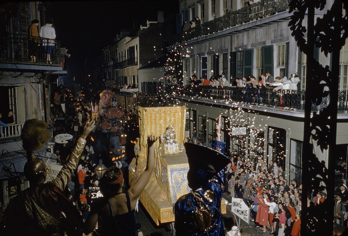 Revelers toss confetti at float of Momus, patron god of Mardi Gras, in New Orleans in 1960 (John E. Fletcher and Robert F. Sisson—National Geographic/Getty Images)