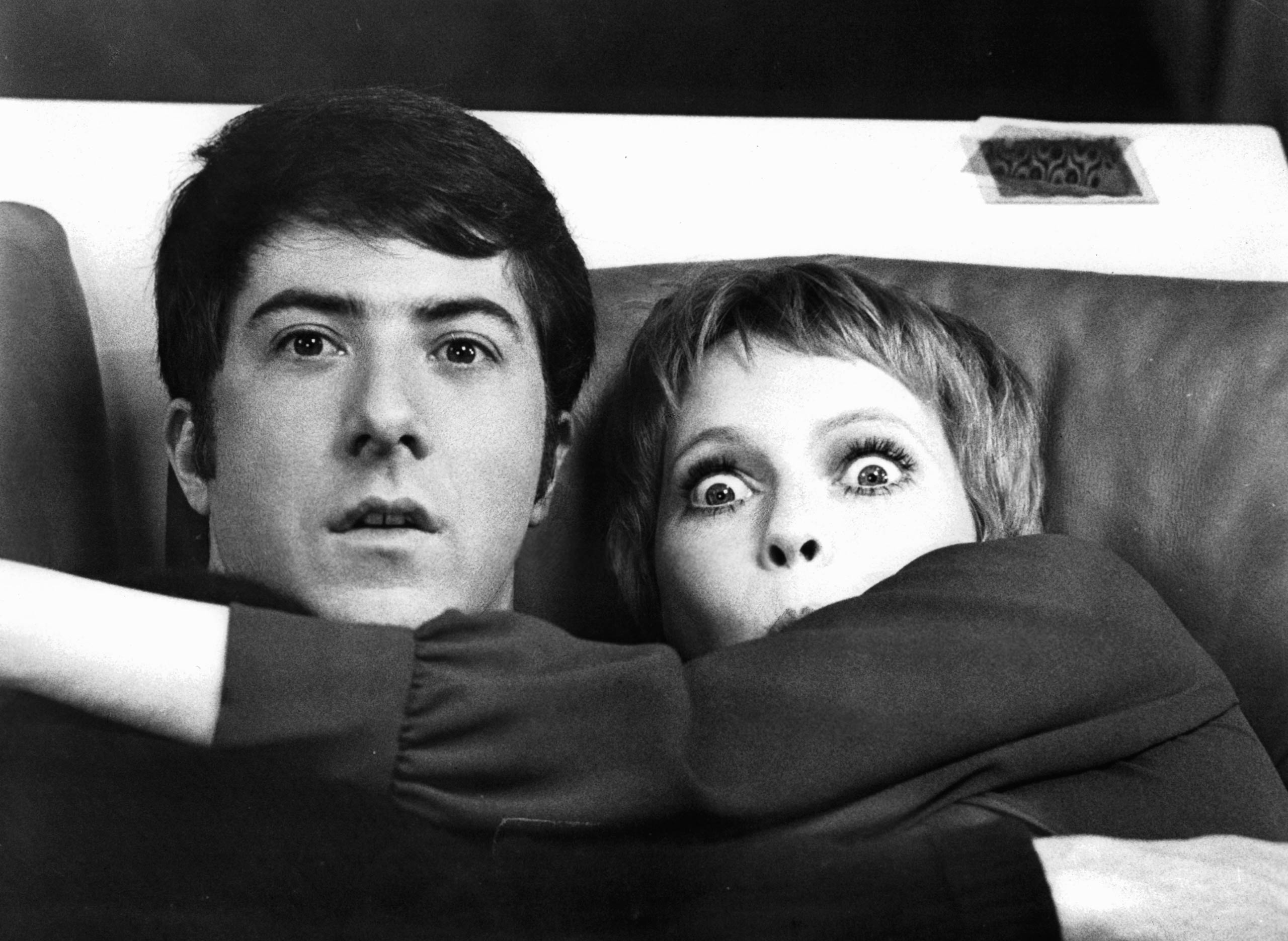 Dustin Hoffman and Mia Farrow hold each other in shock in a scene from John and Mary, 1969.