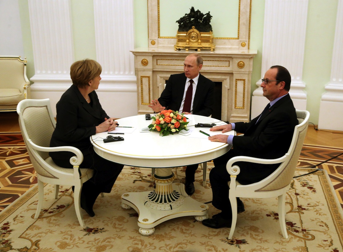 Russian President Vladimir Putin (C) attends a meeting with German Chancellor Angela Merkel (L) and French President Francois Hollande (R) on Feb. 6, 2015 in Moscow, to discuss the conflict in Ukraine (Sasha Mordovets—Getty Images)