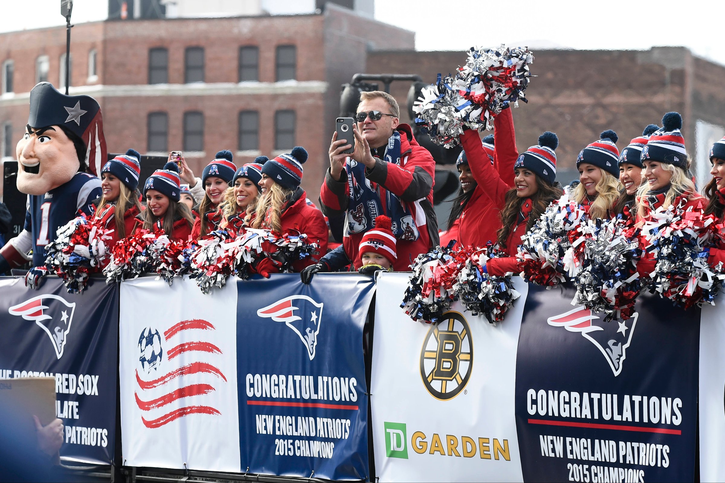 Former New England Patriot Scott Zolack rides with the cheerleaders during a parade held in Boston to celebrate the team's victory over the Seattle Seahawks in Super Bowl XLIX on February 4, 2015.
