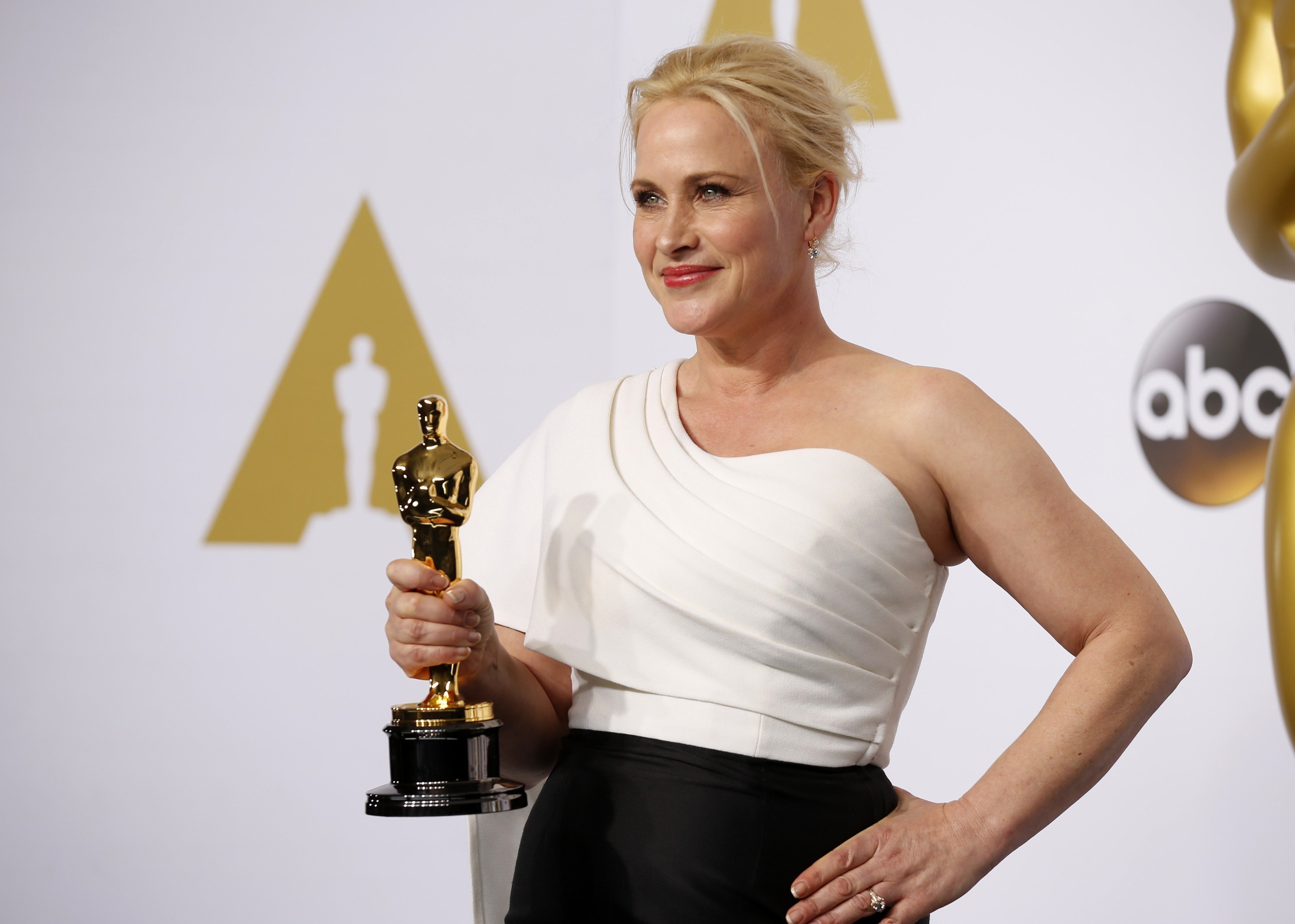 Patricia Arquette, best supporting actress winner for her role in "Boyhood," poses with her award during the 87th Academy Awards in Hollywood