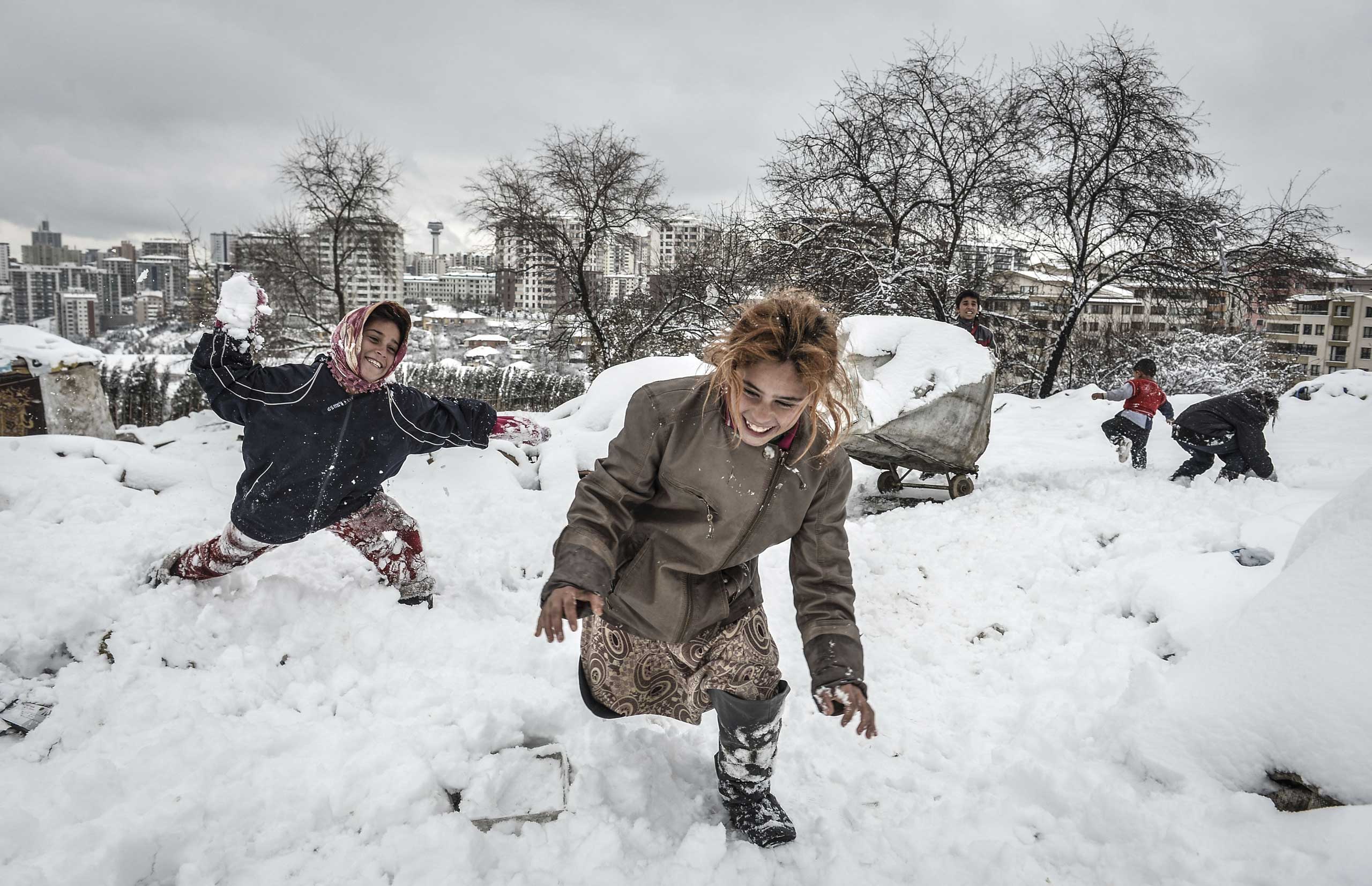 Feb. 11, 2015. Syrian kids, fled with their families from attacks of ISIS, play with snow, in front of a hovel as they live in harsh conditions in cold winter time in Turkey's capital Ankara's suburbs.