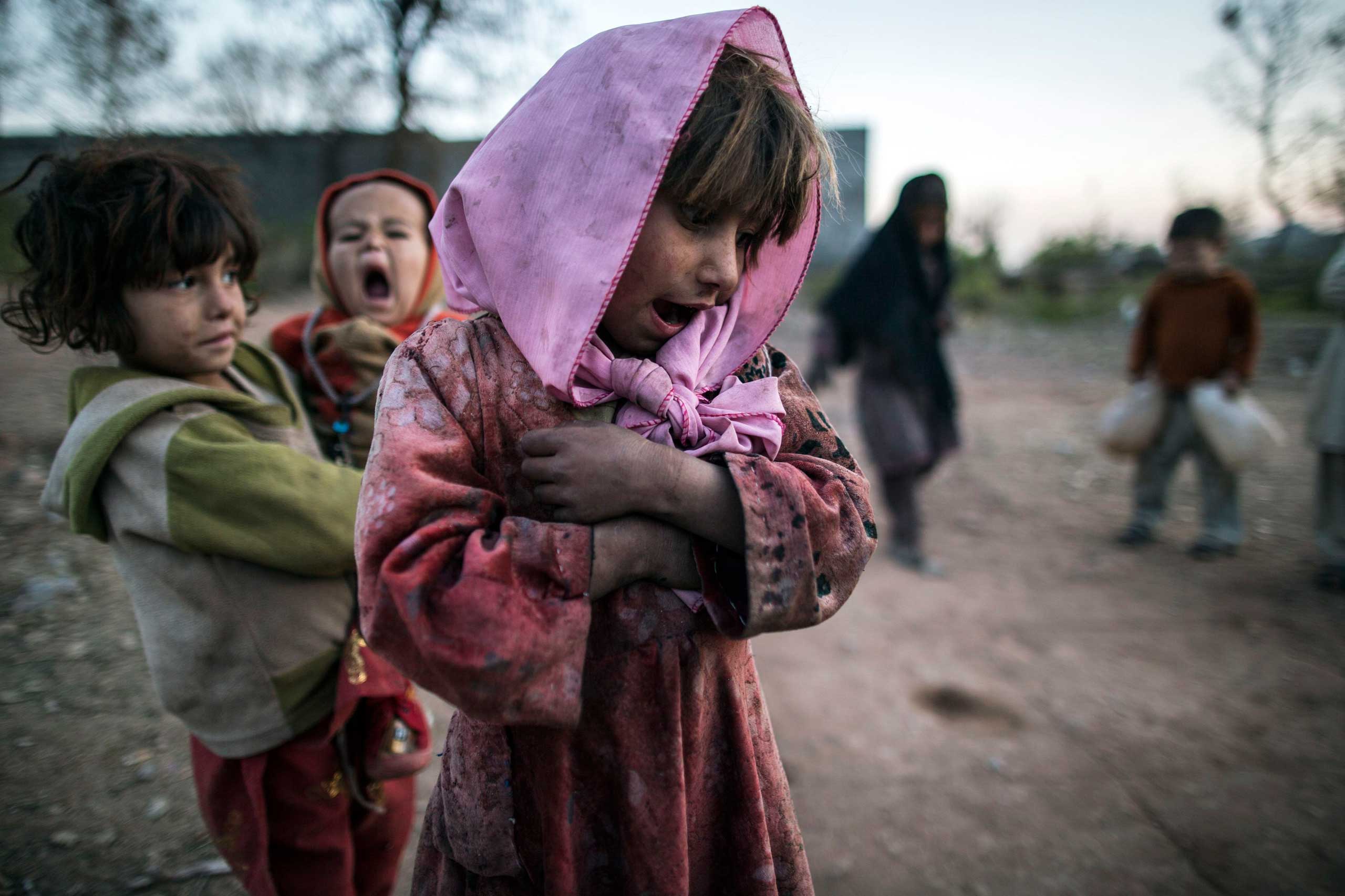 Feb. 11, 2015. A girl reacts as she watches her friend play hopscotch on the outskirts of Islamabad, Pakistan.