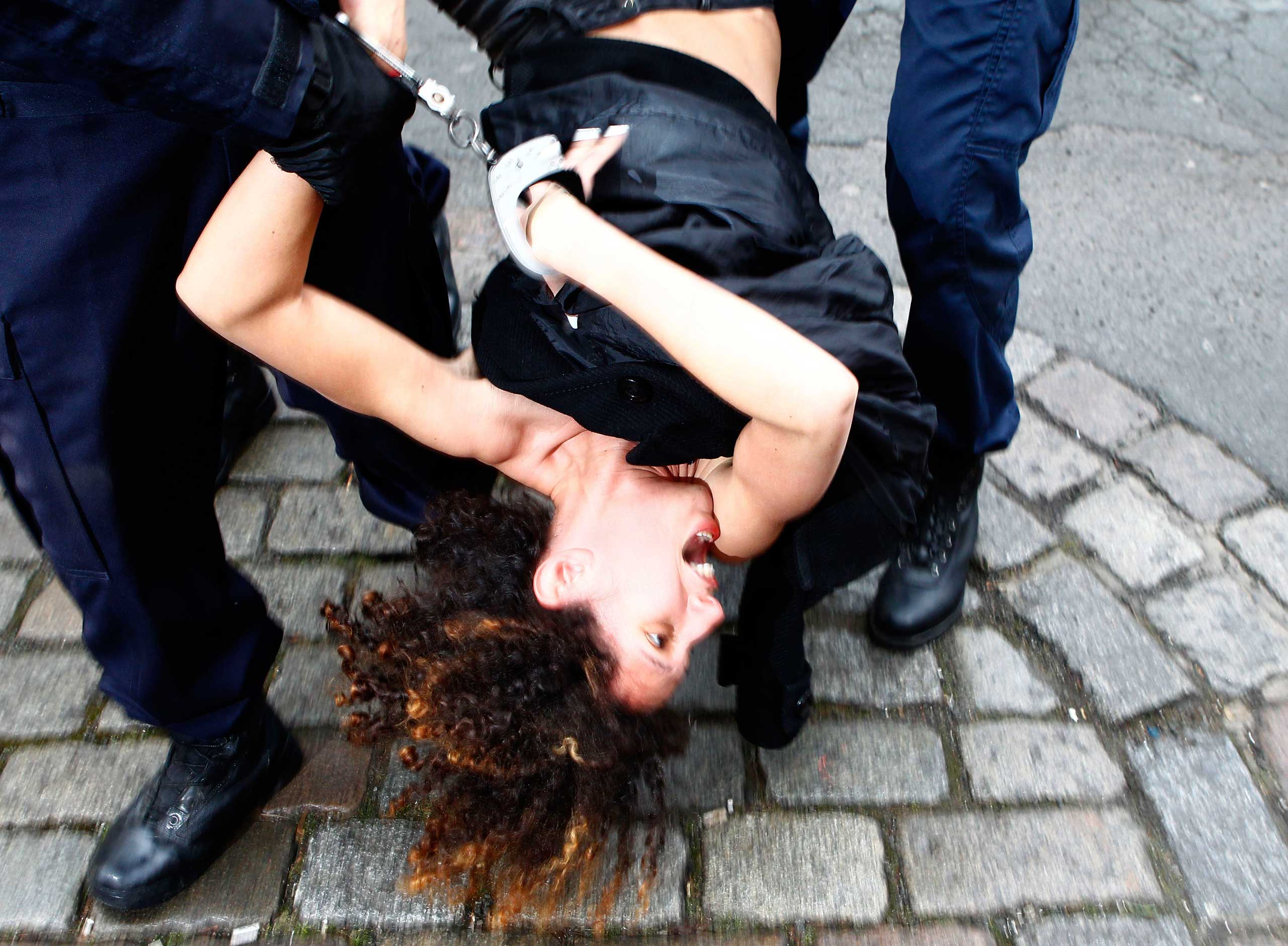 Feb. 10, 2015. A Femen activist is taken away by police officers as she protests in front of the Lille courthouse in Lille, northern France, where Dominique Strauss-Kahn goes on trial for sex charges in France. The former head of the International Monetary Fund, whose career went down amid accusations of sexually assaulting a hotel maid in New York, is facing similarly charges in France for aggravated pimping and involvement in a prostitution ring operating out of luxury hotels.