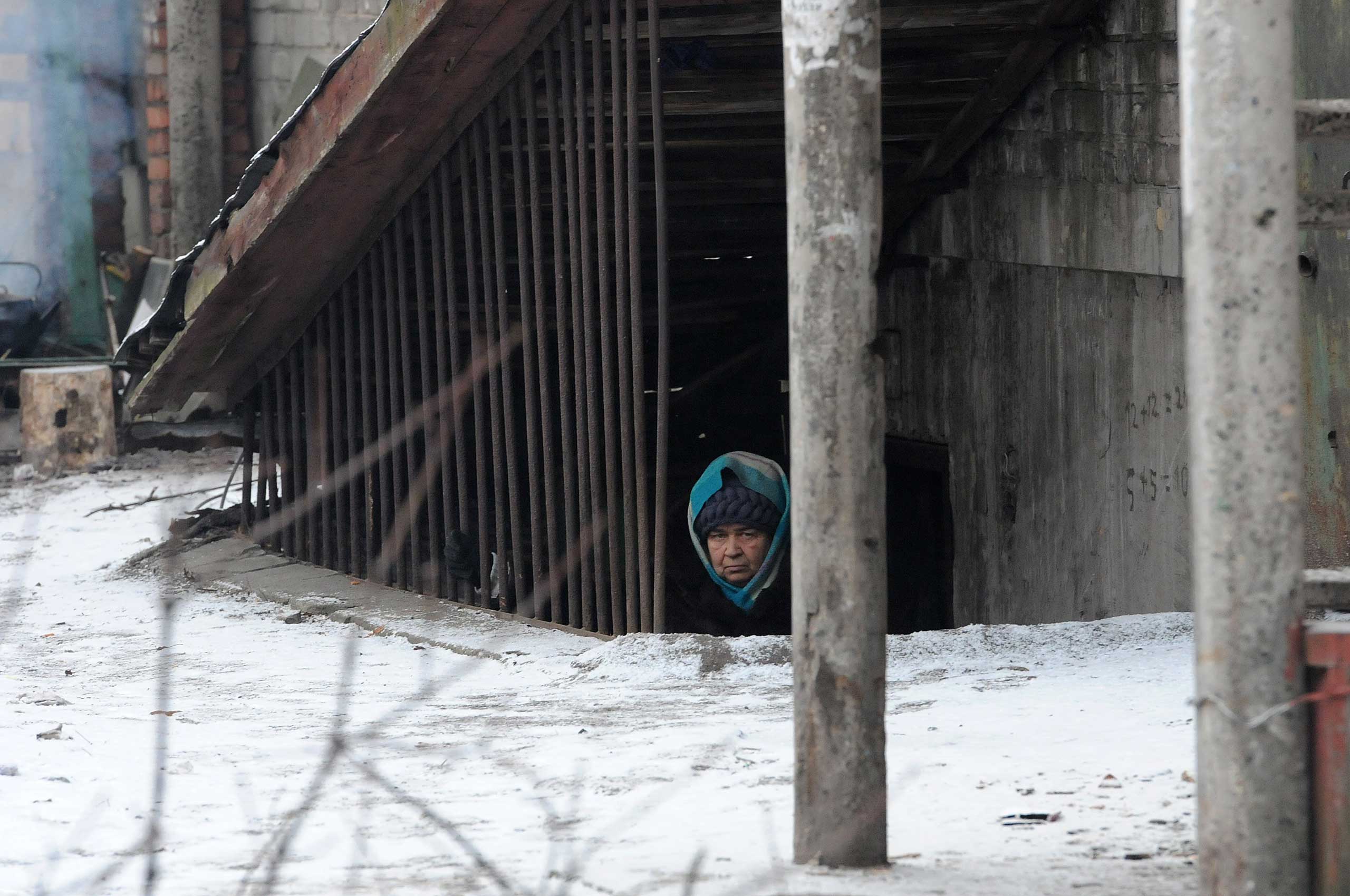 Feb. 9, 2015. A woman takes refuge as her area is under shelling attacks from pro-Russian separatist forces in Debalteve, Donbass Oblast, Ukraine.