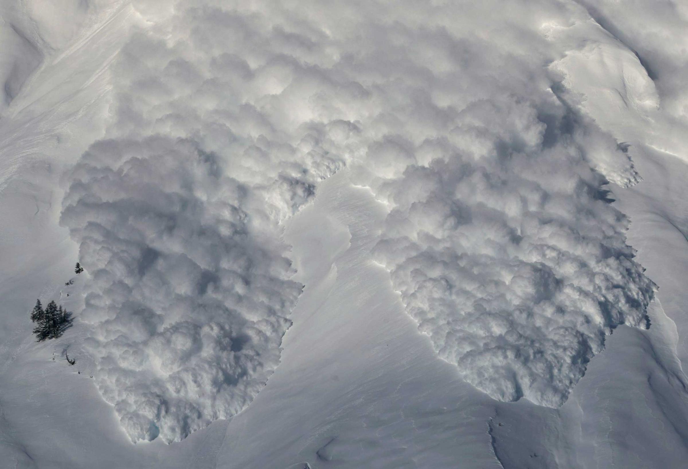 An artificially triggered avalanche thunders down a mountain side at the Vallee de la Sionne in Anzere