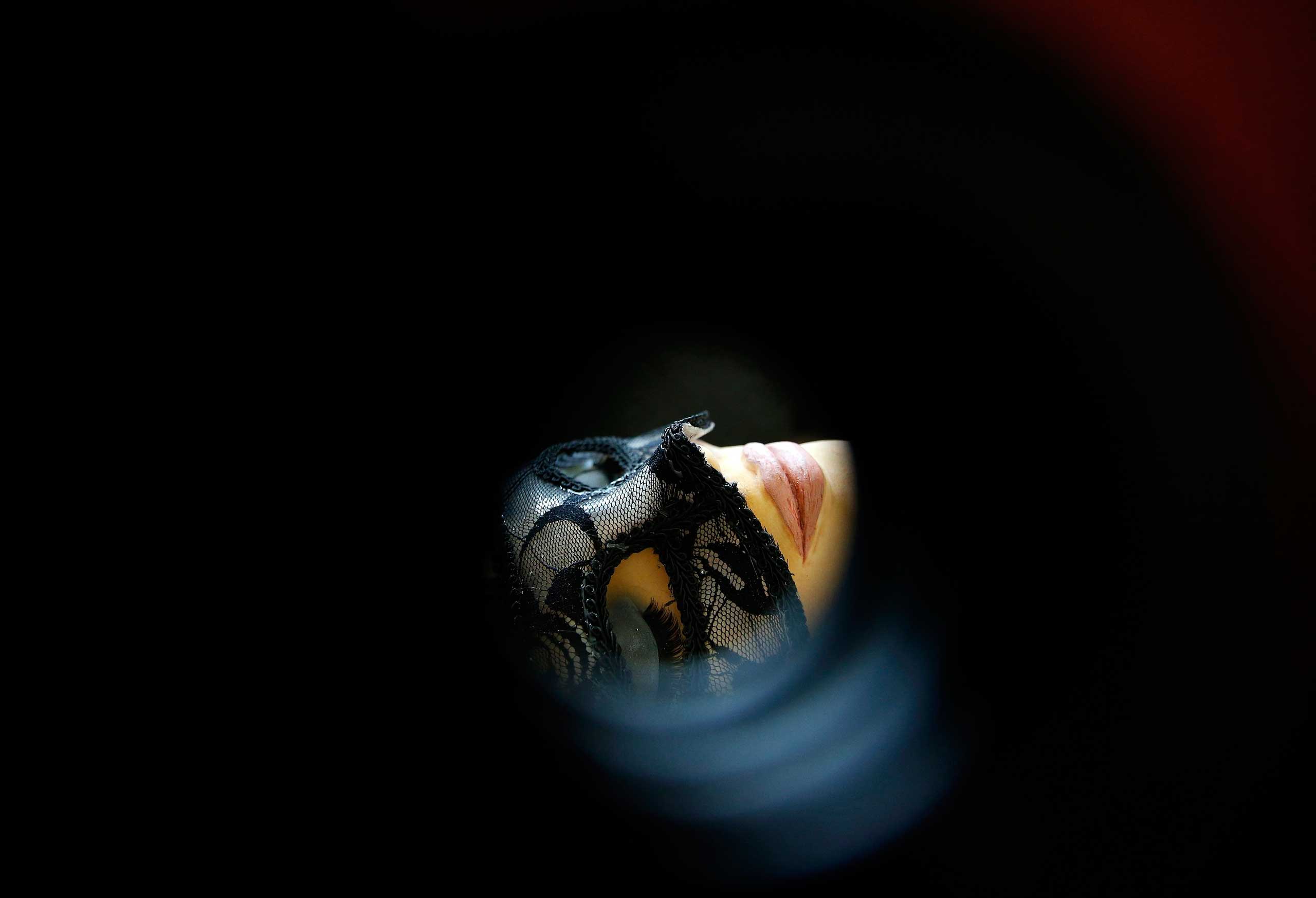 Feb. 6, 2015. A cake in the form of a woman in a mask from the book  Fifty Shades of Grey  is viewed through a peep hole as part of a display entitled  Fifty Shades of Cake , on the opening day of the Cake International show in Manchester, northern England.