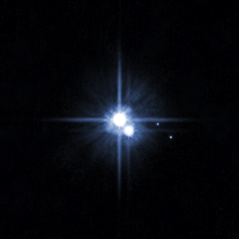 This undated image taken by the Hubble telescope shows Pluto and its moons: Charon, Nix, and Hydra. (NASA / Getty Images)