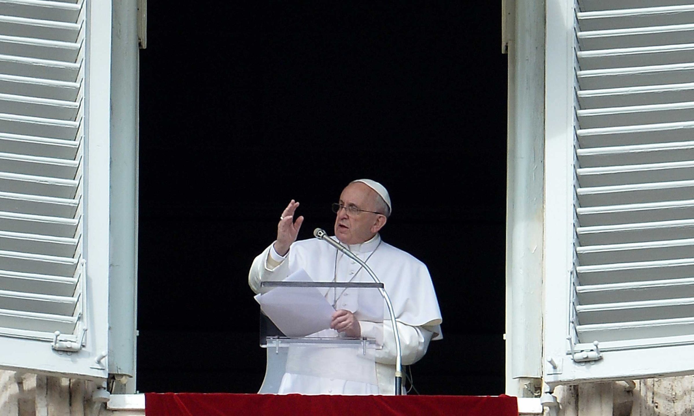 Pope Francis addresses the crowd from the window of the apostolic palace overlooking Saint Peter's square during his Angelus prayer on Feb. 22, 2015 at the Vatican.