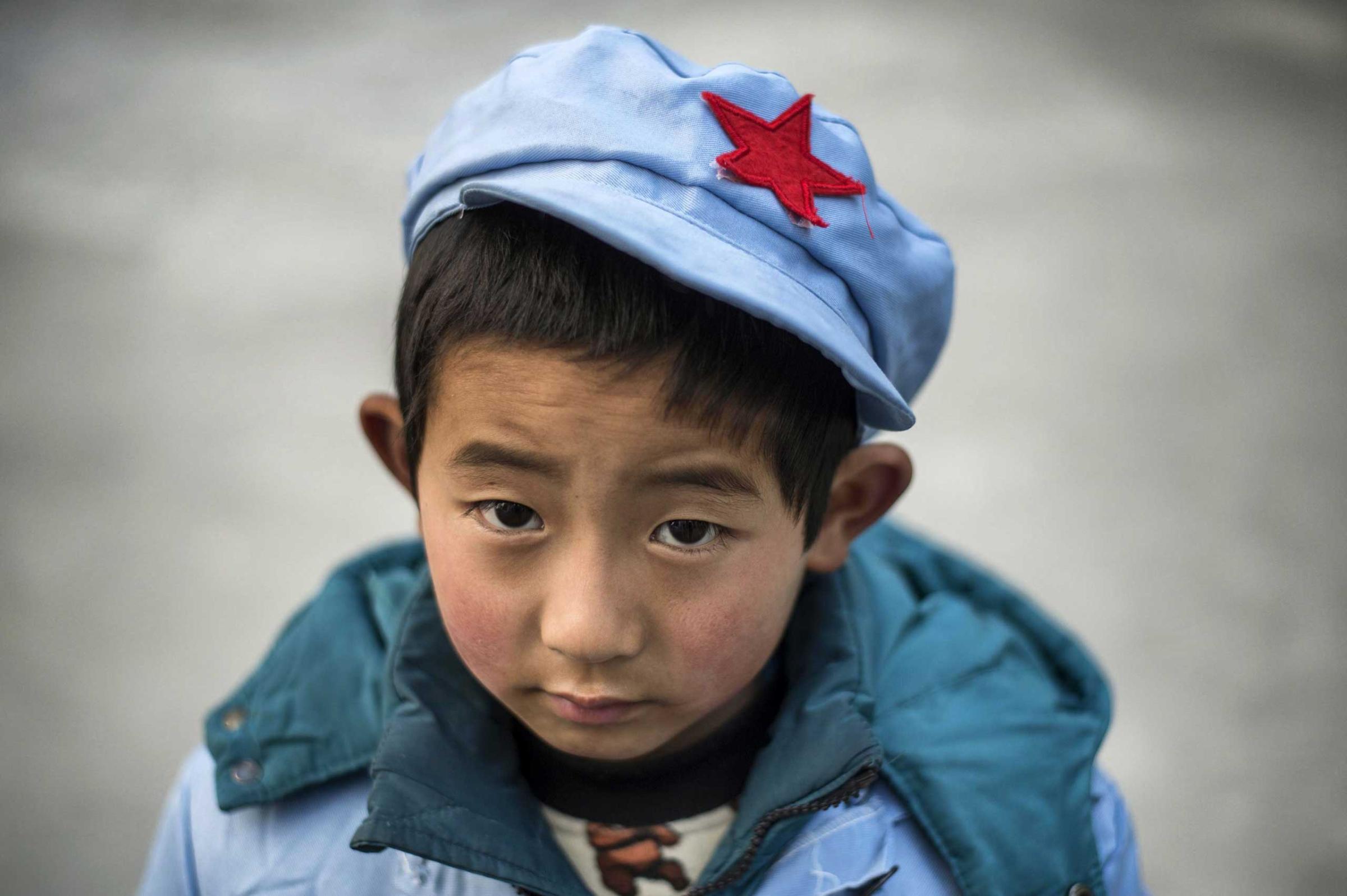 A boy waits at the Beichuan Red army elementary school.