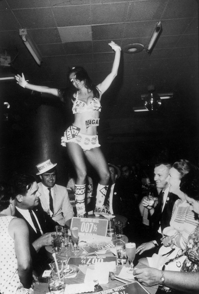 Go-go girl and delegates during the 1968 Republican National Convention, Miami Beach, Florida.