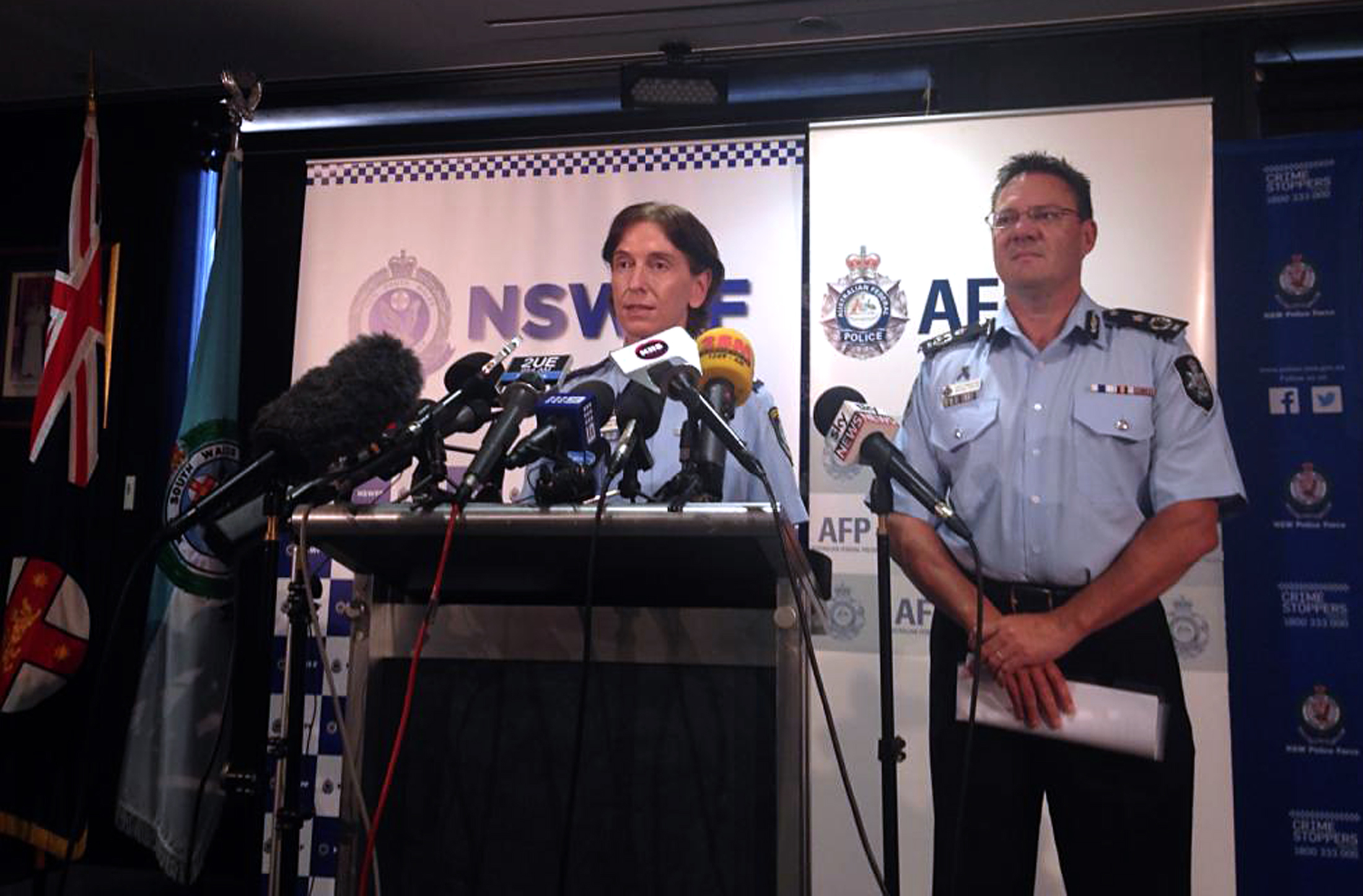 Australian Federal Police Deputy Commissioner Michael Phelan (R) listens as New South Wales Deputy Police Commissioner Catherine Burn speaks during a media conference in Sydney February 11, 2015