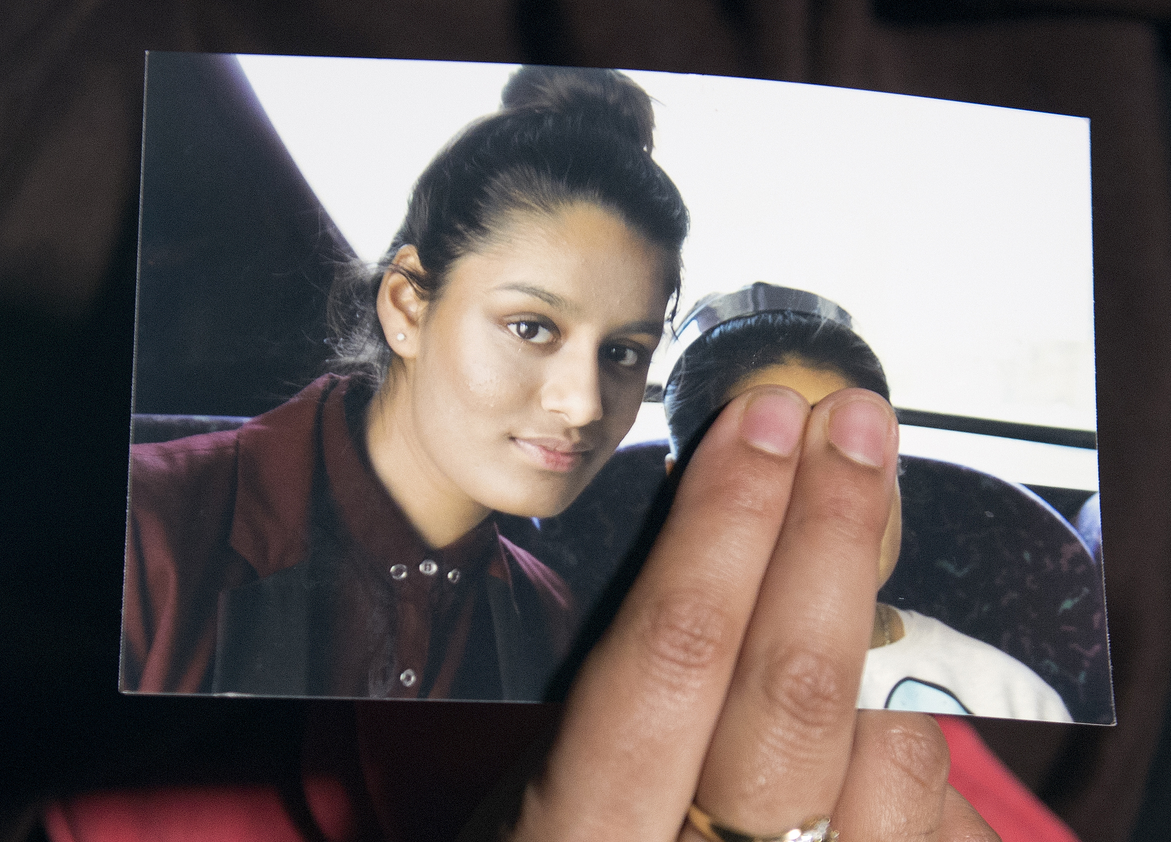 Renu Begun, sister of teenage British girl Shamima Begun, holds a photo of her sister as she makes an appeal for her to return home at Scotland Yard, in London