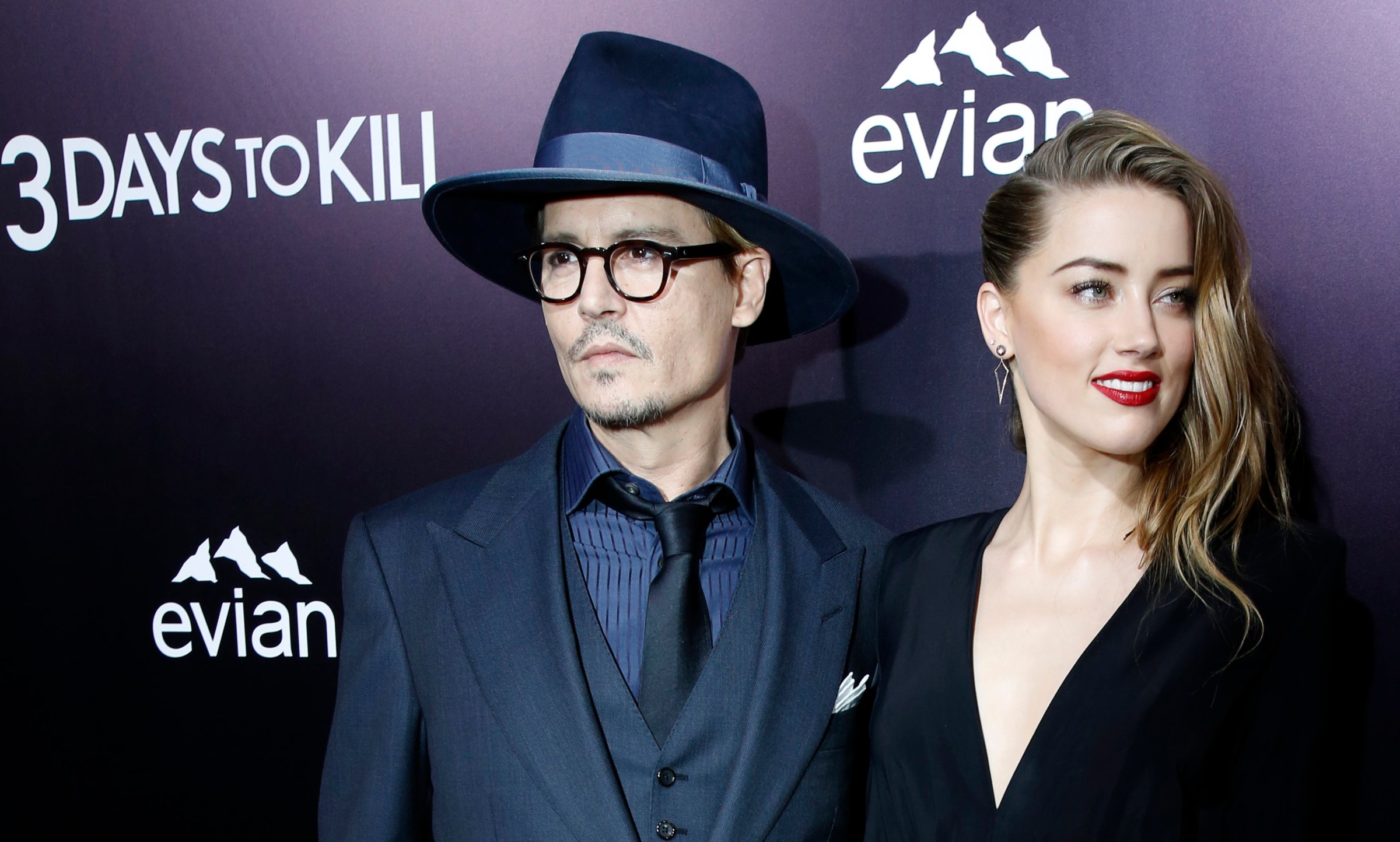 Cast member Amber Heard and her fiance, actor Johnny Depp pose at the premiere of "3 Days to Kill" in Los Angeles