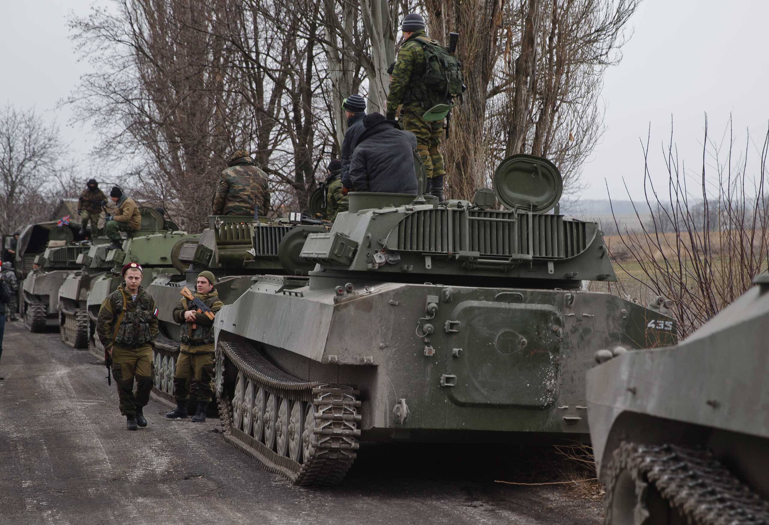 Russia-backed separatist fighters stand next to self propelled 152 mm artillery pieces, part of a unit moved away from the front lines, in Yelenovka, near Donetsk, Ukraine, Feb. 26, 2015. (Vadim Ghirda—AP)