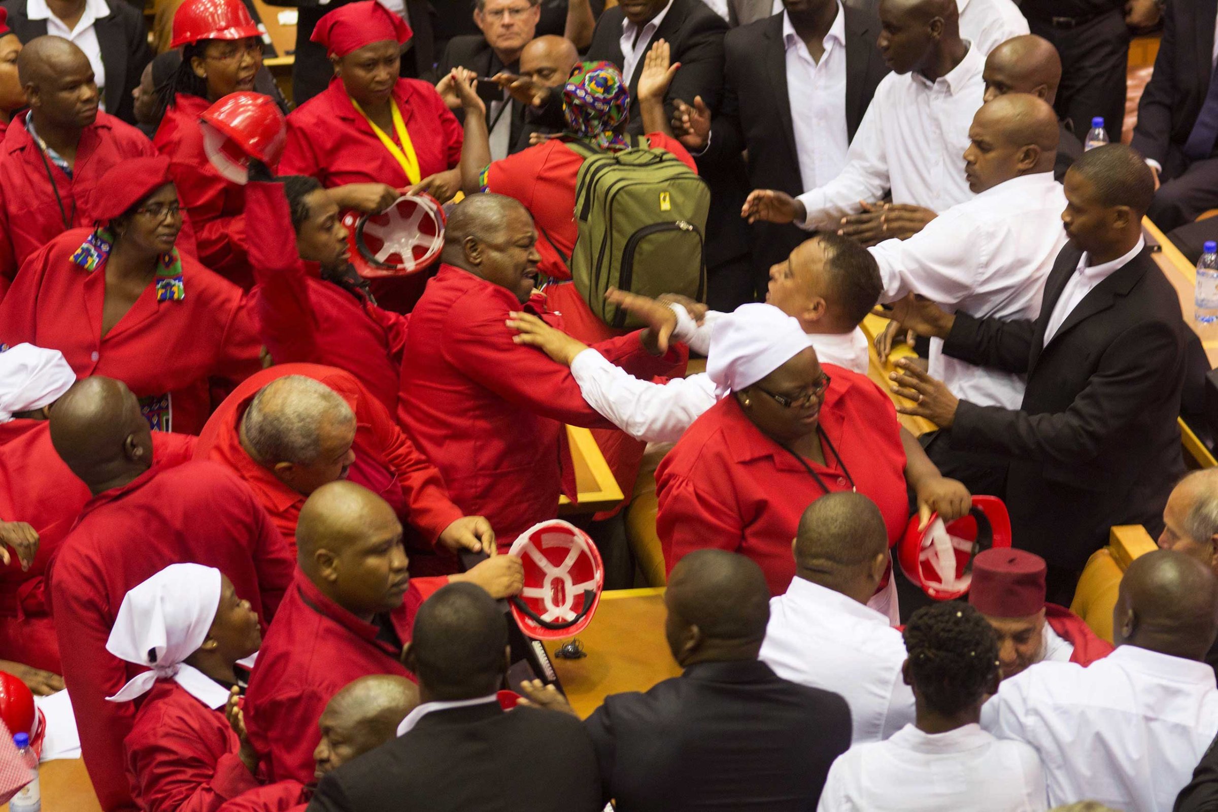 Members of the Economic Freedom Fighters, wearing red uniforms, clash with security forces during South African President's State of the Nation address in Cape Town on Feb. 12, 2015.