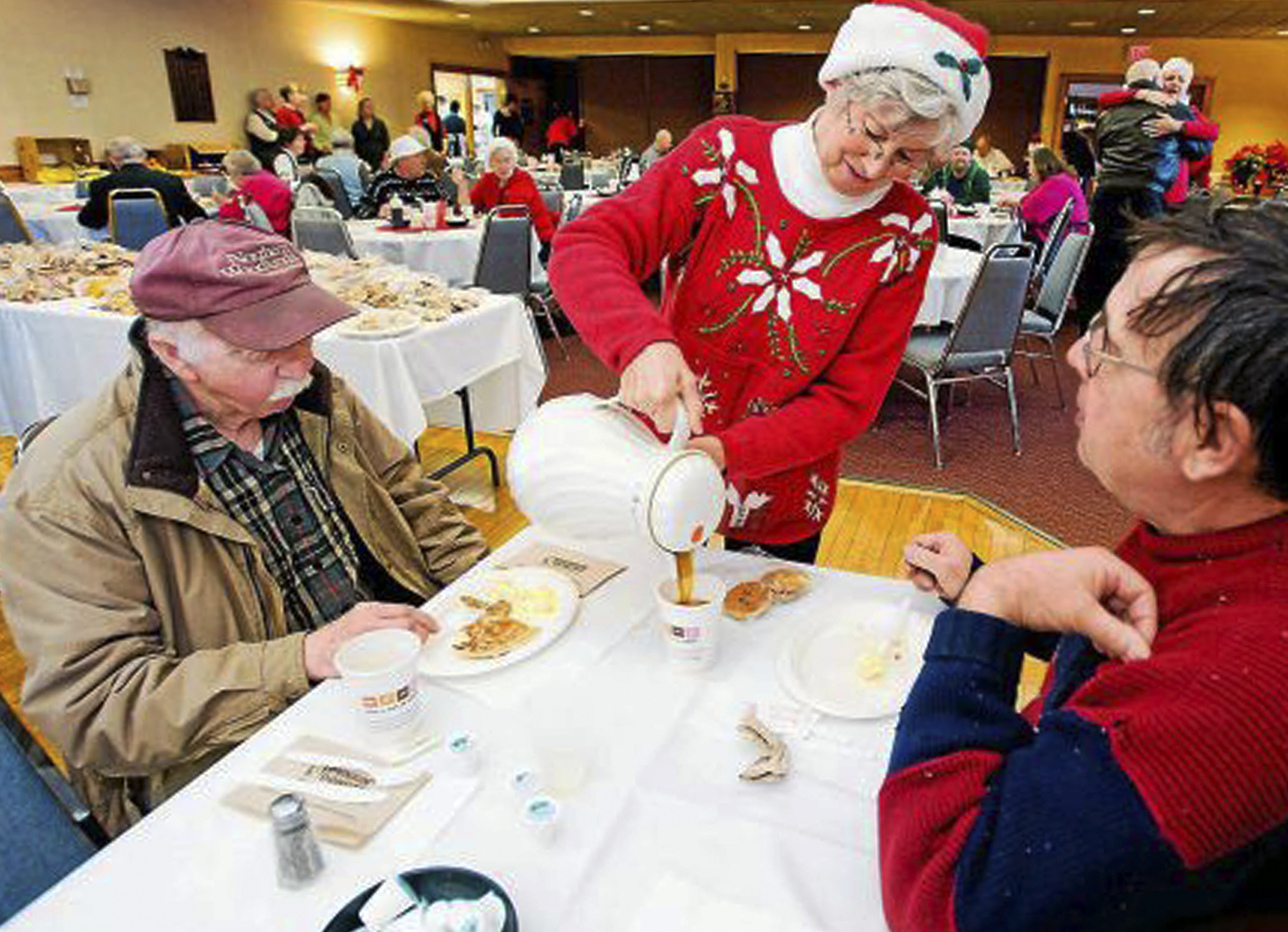 In this December 2011 photo, Connie Howe pours coffee for Ronald Read, left, and Dave Smith during the Charlie Slate Memorial Christmas breakfast at the American Legion in Brattleboro, Vt. (AP&mdash;AP)