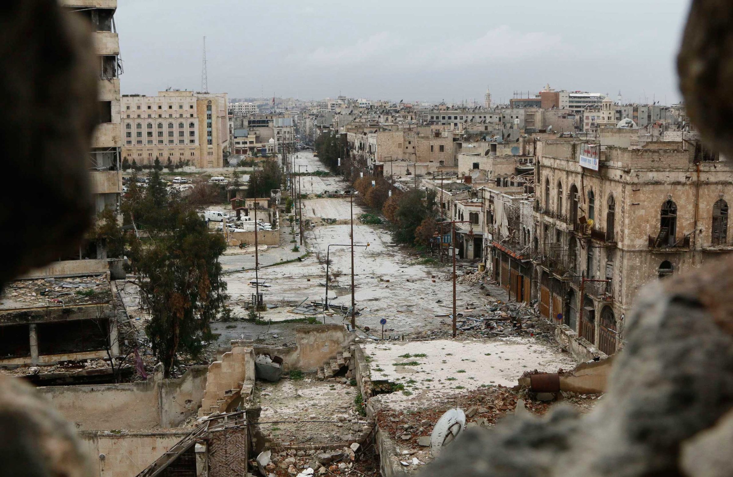 A general view shows damaged buildings along a deserted street and an area controlled by forces loyal to Syria's President Bashar Assad, as seen from a rebel-controlled area at the Bab al-Nasr frontline in Aleppo, Feb. 10, 2015.