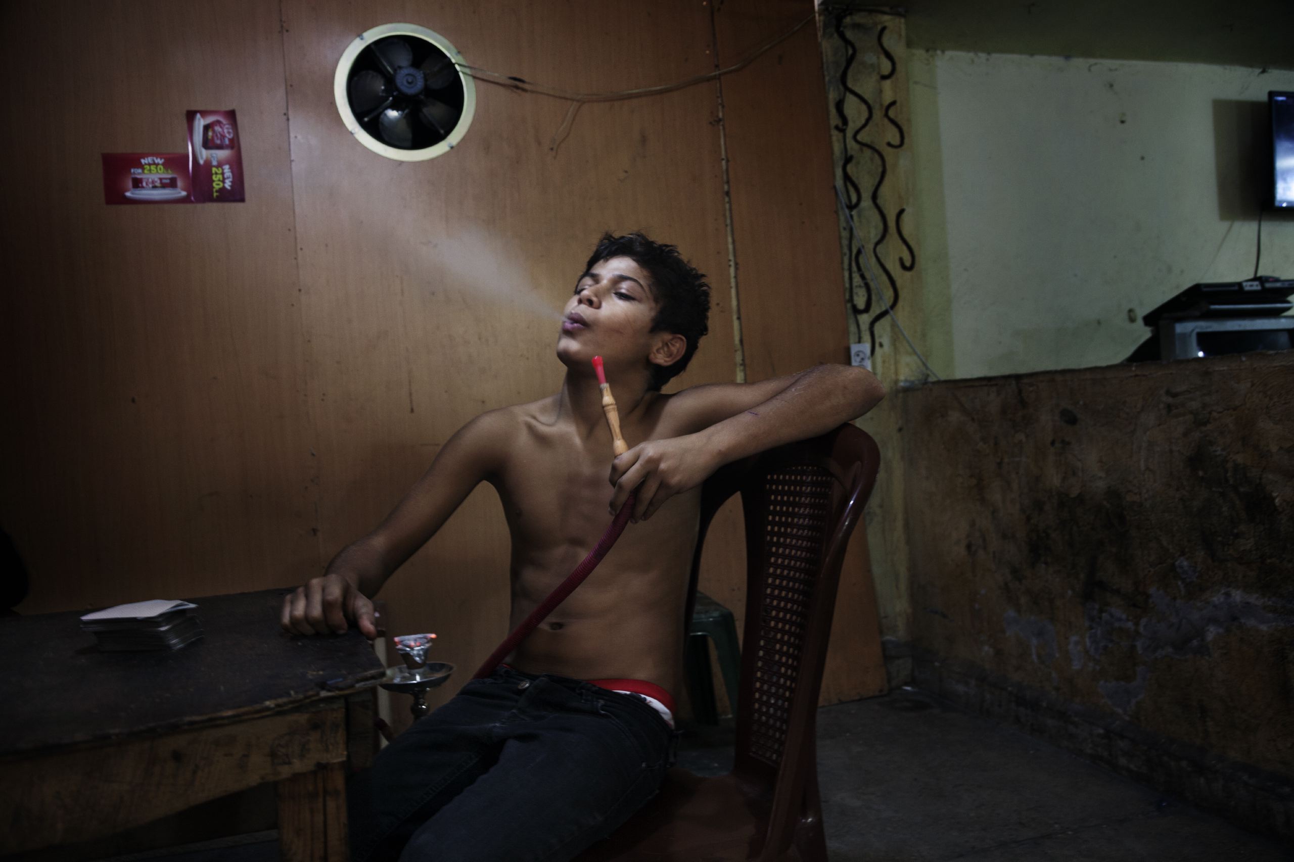 A young boy smoking his shisha in the neighborhood of Bab al-Tabbaneh, Tripoli, Lebanon, Nov. and Dec. 2014.
