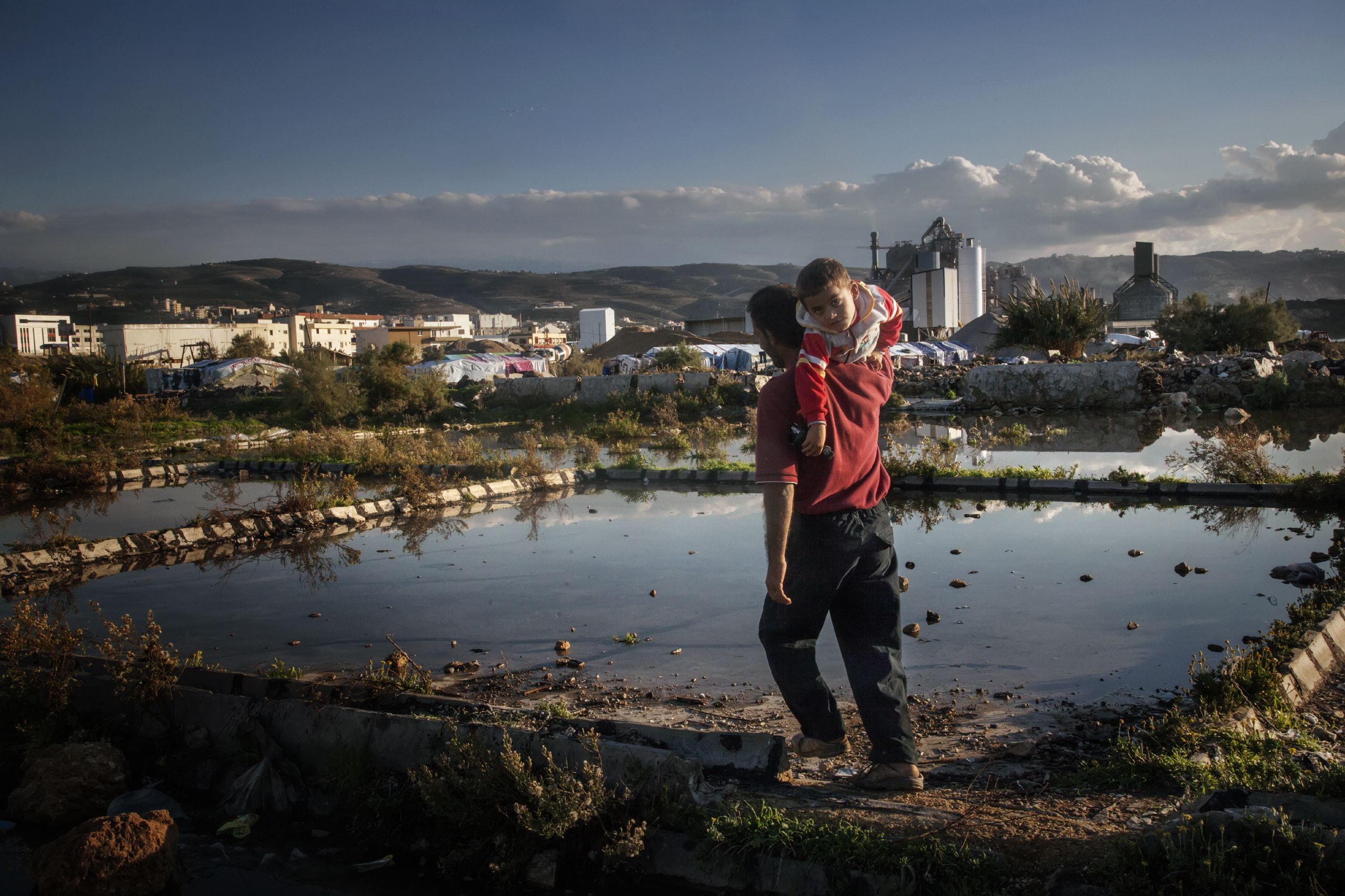 A father with his son in the informal refugee camp in Enfe, a suburb of Tripoli, Lebanon, Nov. and Dec. 2014.
