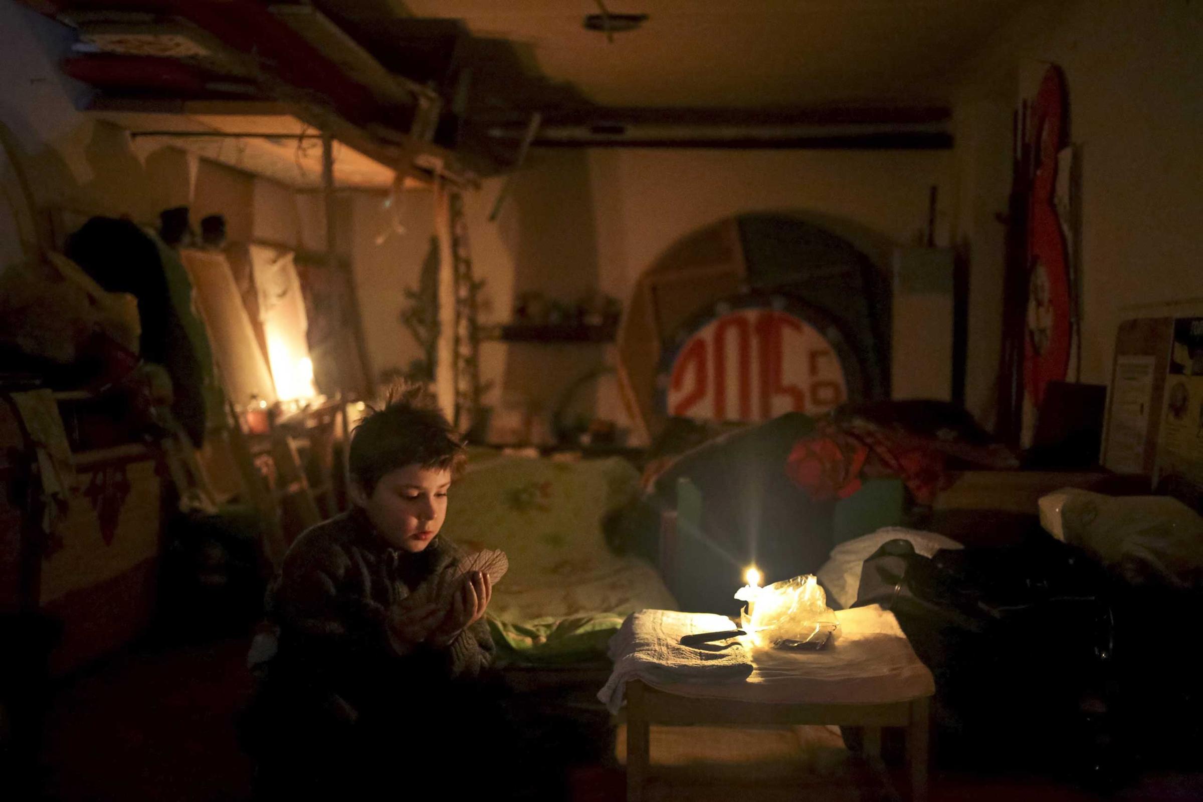 A child plays cards in the local House of Culture which is used as a bomb shelter in Mironovka village, Feb. 17, 2015.