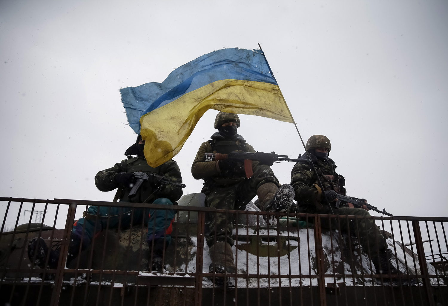 Members of the Ukrainian armed forces ride on a military vehicle near Debaltseve