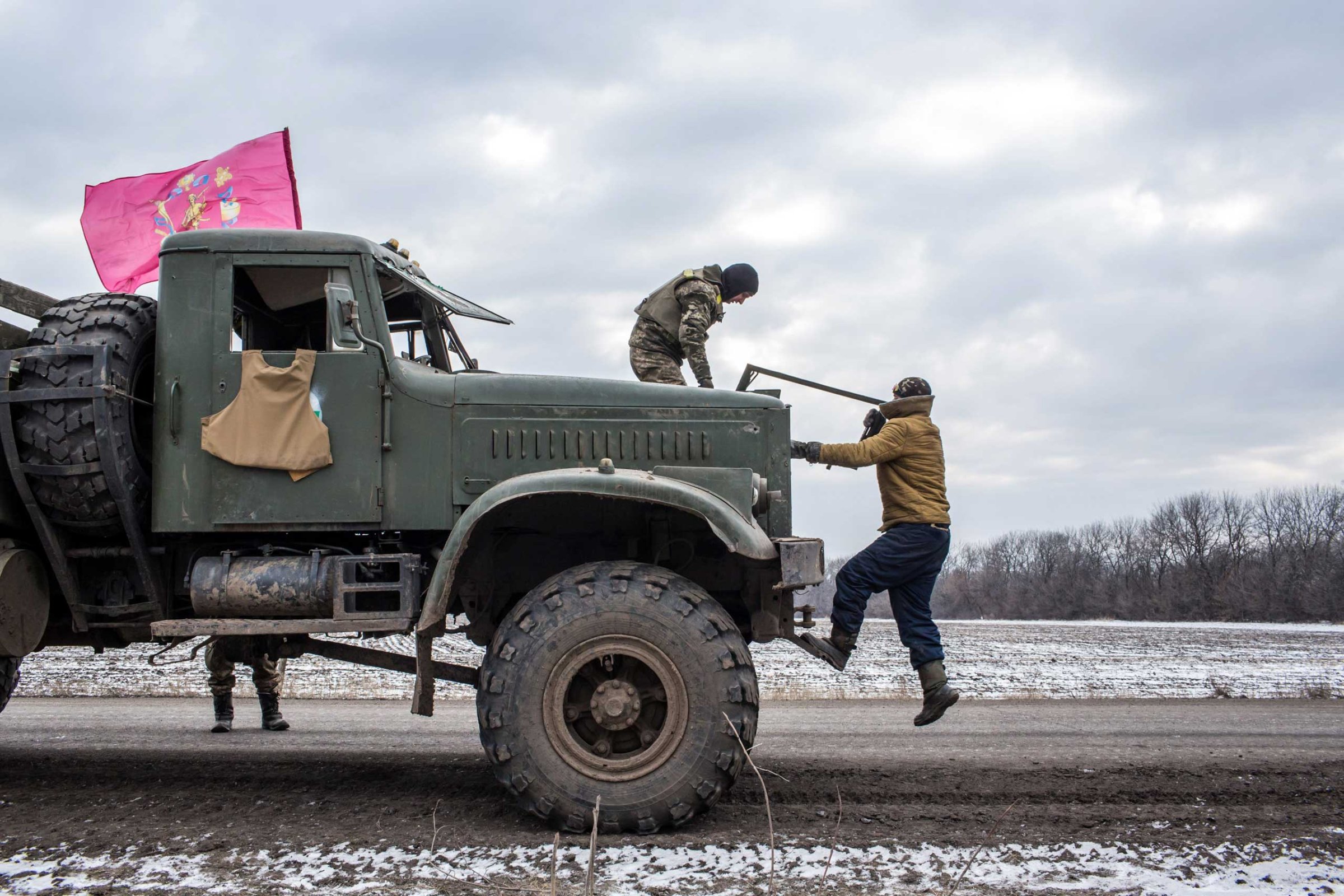 Ukrainian soldiers from a unit based in Zaporizhia repair the bullet-shattered windshield of a truck after taking fire during their withdrawal from Debaltseve the previous day on Feb. 19, 2015 in Artemivsk.