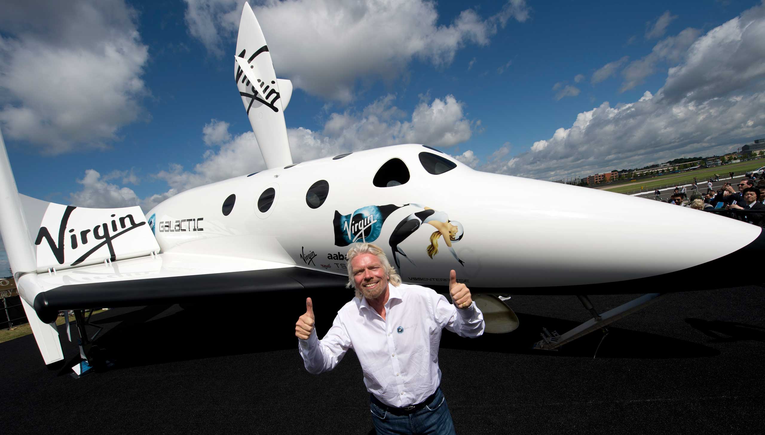 British billionaire Richard Branson poses in front of a model of the Virgin Galactic. (Adrian Dennis—AFP/Getty Images)