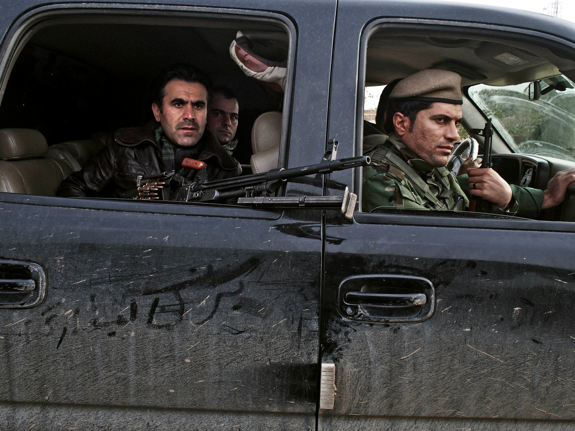 Counterattack: Kurdish soldiers drive through an Iraqi village in December after taking it back from ISIS forces