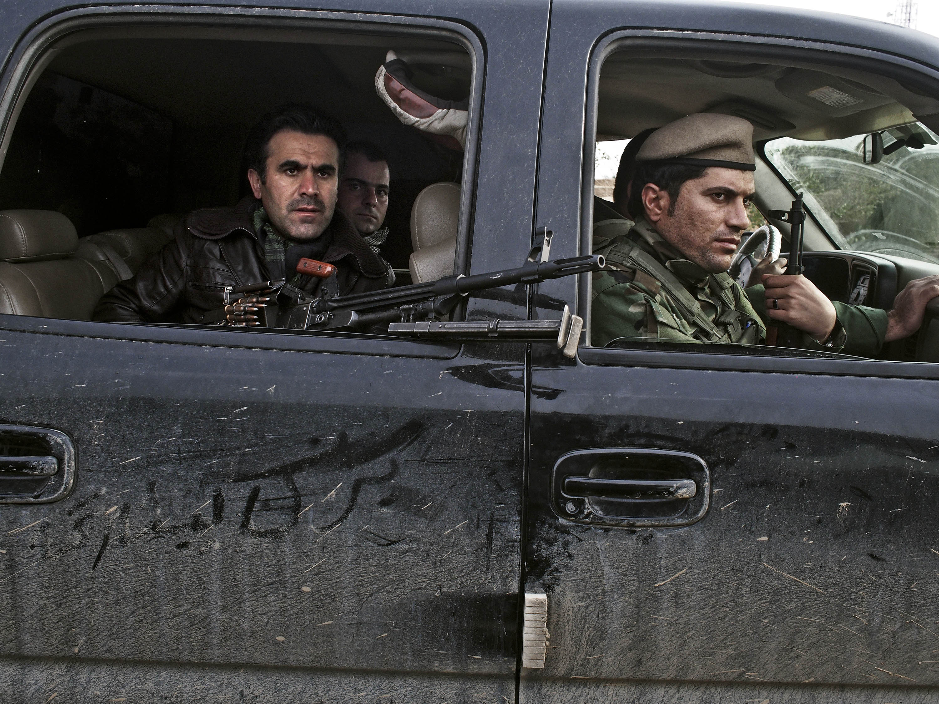 Counterattack: Kurdish soldiers drive through an Iraqi village in December after taking it back from ISIS forces (Moises Saman—Magnum)