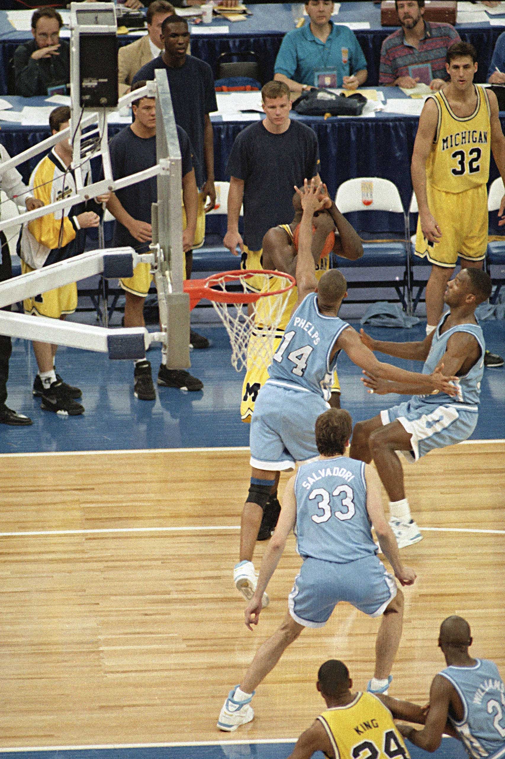 Michigan's Chris Webber, guarded by North Carolina's Derrick Phelps, calls a timeout in the closing moments of the NCAA finals at the Super Dome in New Orleans, April 5, 1993. Webber was called for a technical foul because they had no time outs left and North Carolina went on to win, 77-71. (AP Photo/Bill Haber)