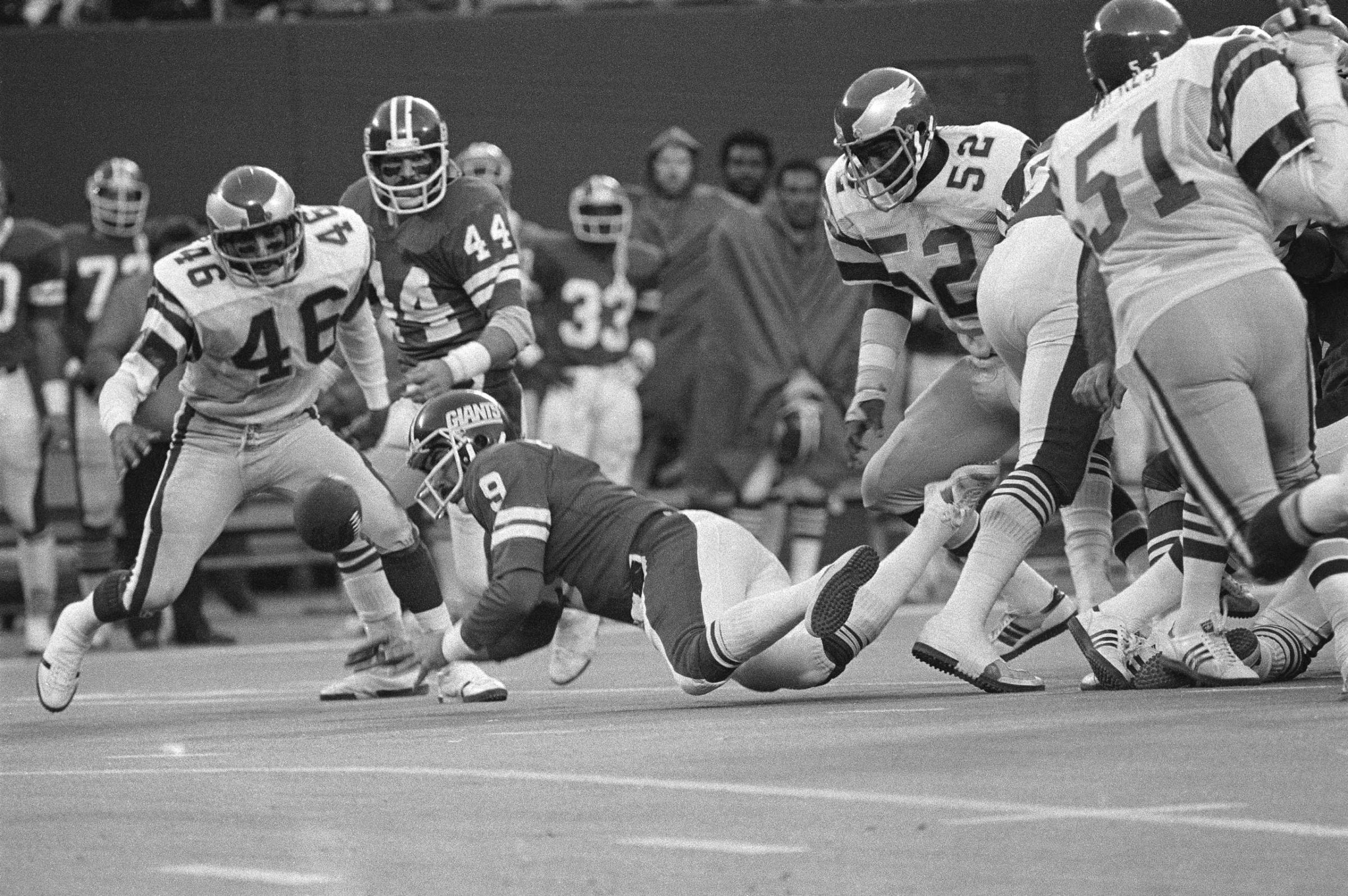 Herman Edwards (46) of the Philadelphia Eagles chases the New York Giant fumble during the final minutes of the contest in East Rutherford, N.J., Nov. 19, 1978. The Giants' quarterback Joe Pisarcik (9) had trouble with the hand off and Edwards was able to go in with the score. The Eagles surprised the Giants 19-17. (AP Photo/G. Paul Burnett)