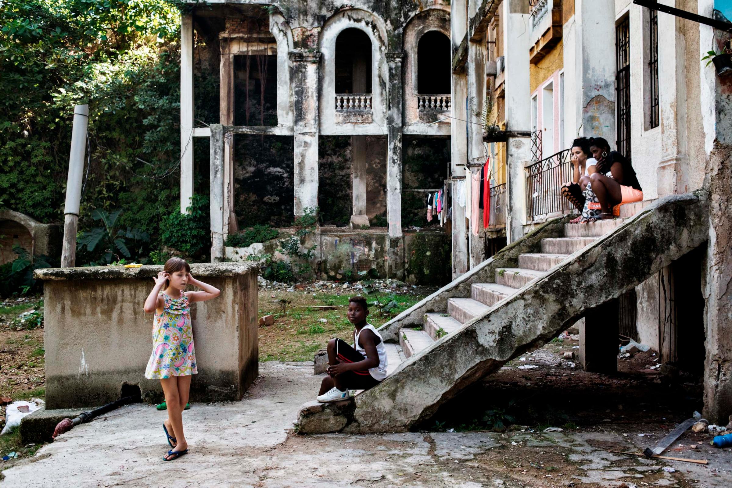 December 2015. Young girls play on the grounds of the Arcos building, an iconic building in the El Vedado neighborhood of Havana.