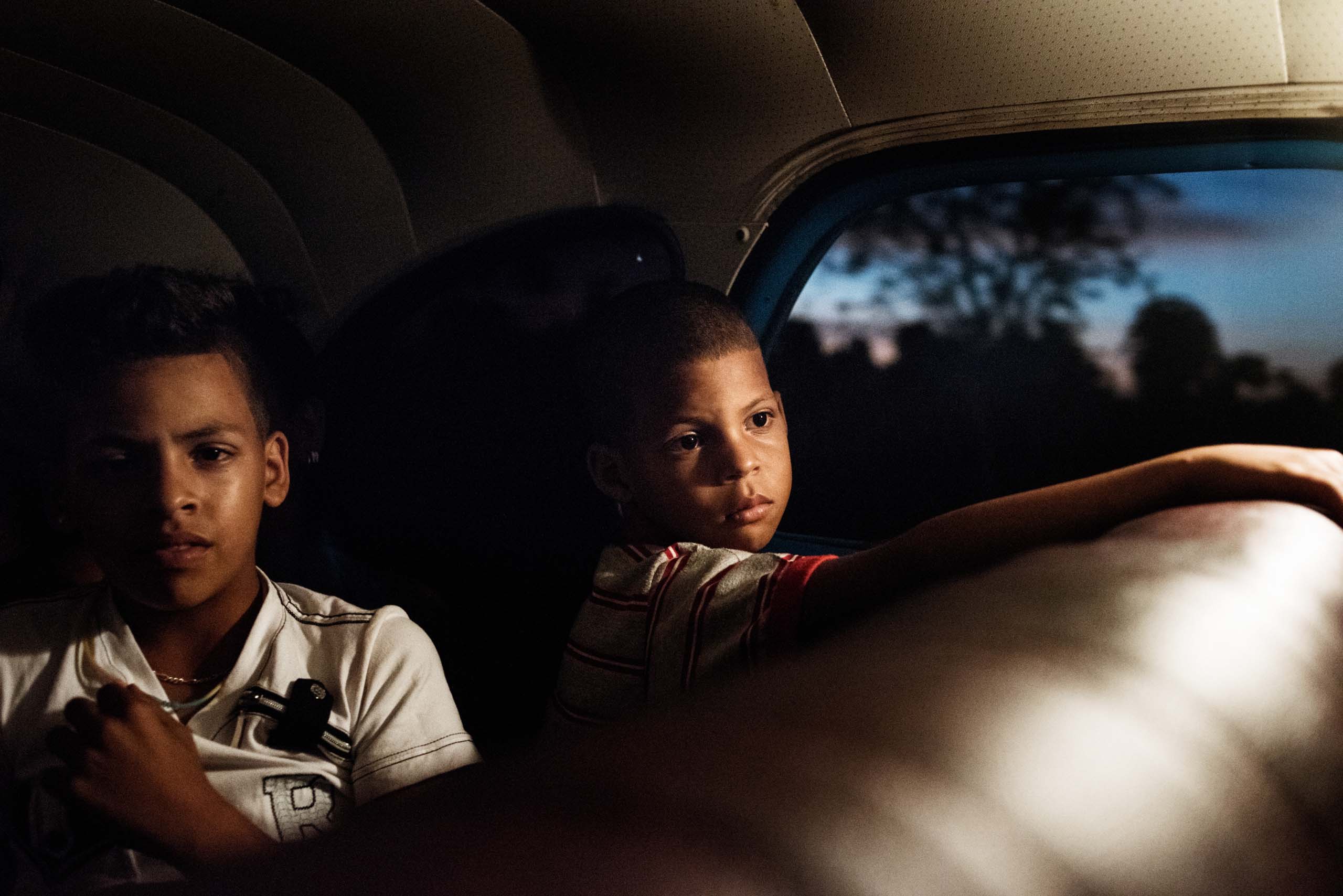 January, 2015. Children ride in a private taxi in Havana. Taxis, both shared and private, are the main form of transport for many Cubans.