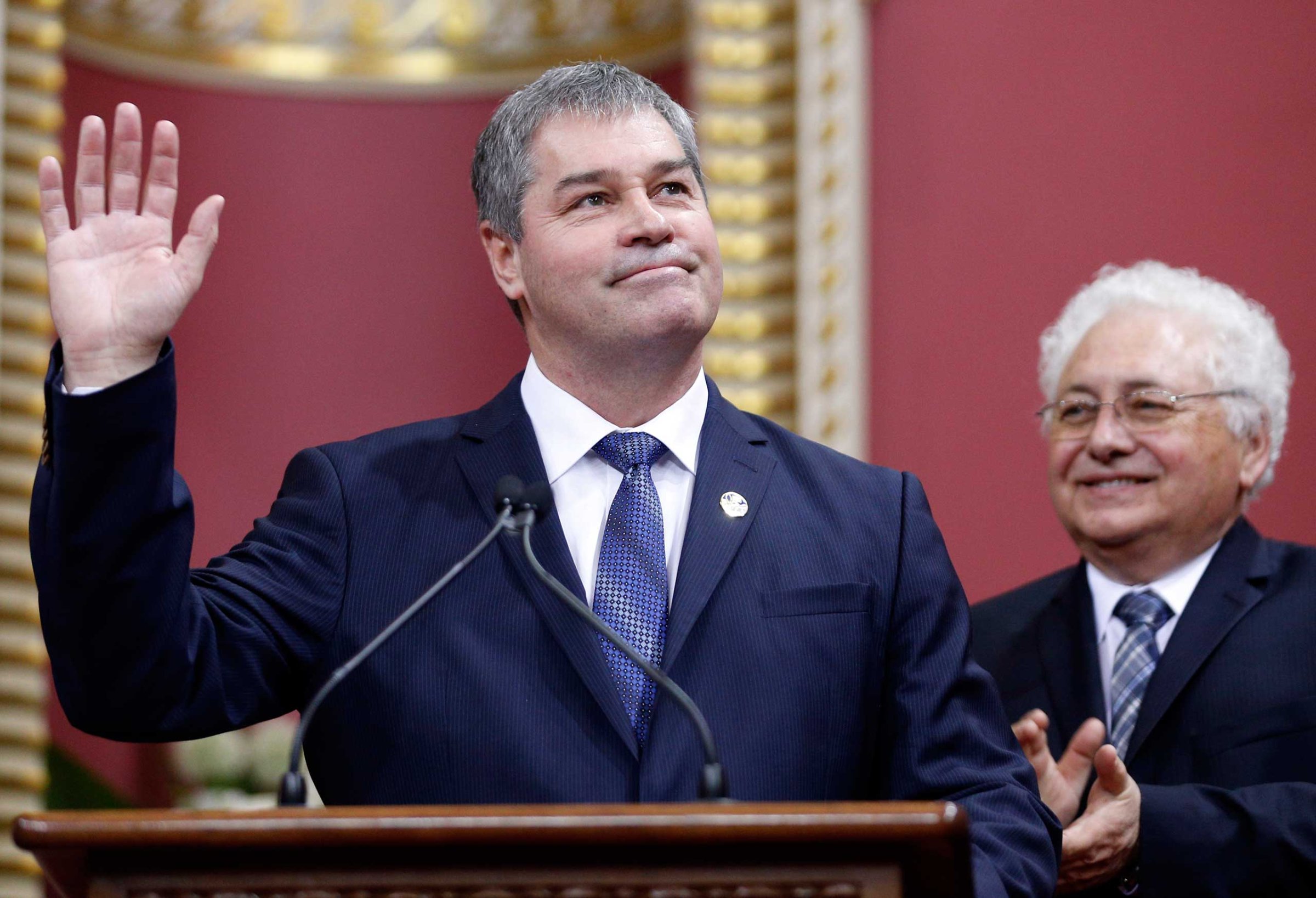 Quebec's Minister of Education Yves Bolduc waves to the crowd after being appointed by Premier Philippe Couillard during a swearing-in ceremony at the National Assembly in Quebec City, April 23, 2014.