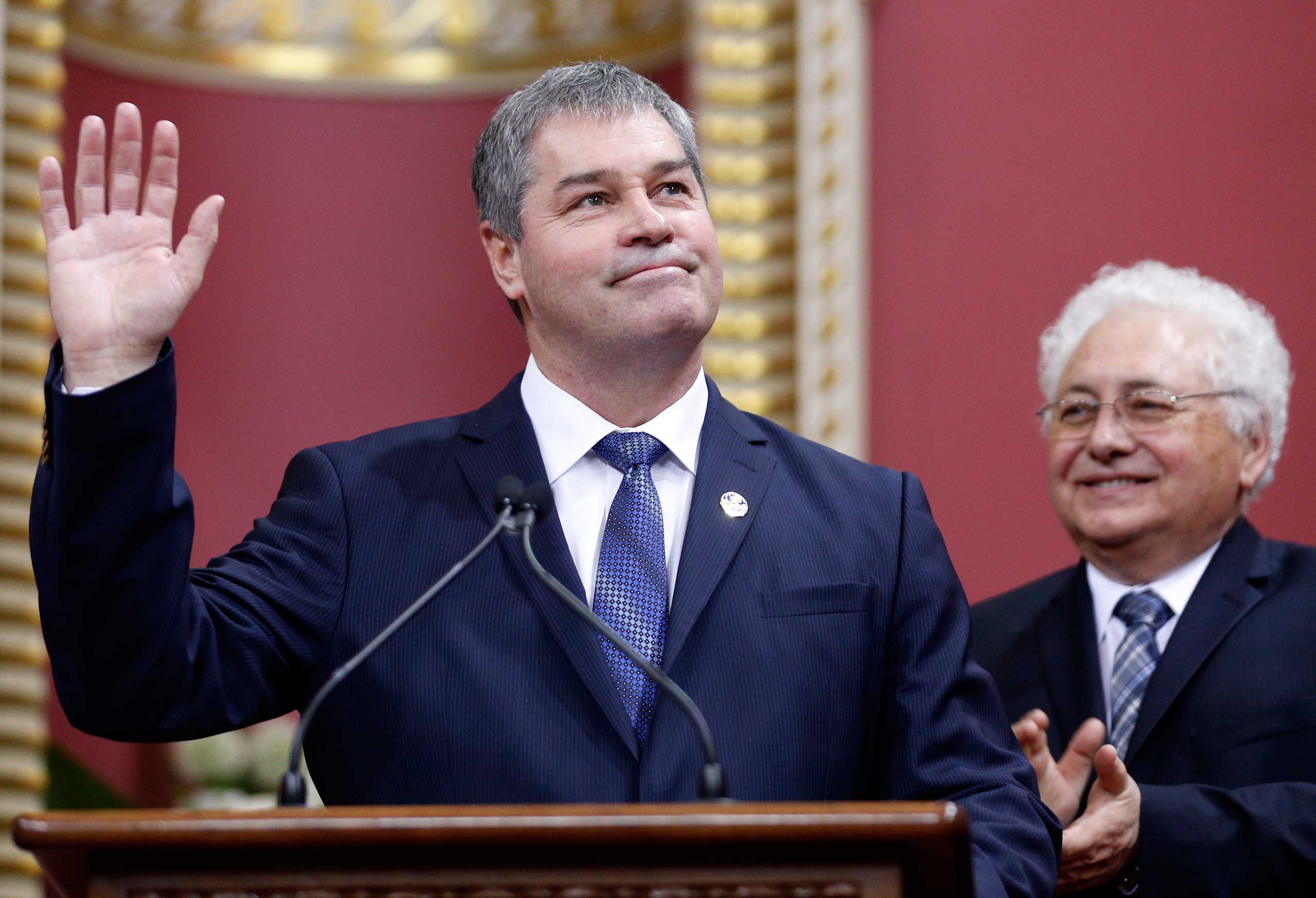 Quebec's Minister of Education Yves Bolduc waves to the crowd after being appointed by Premier Philippe Couillard during a swearing-in ceremony at the National Assembly in Quebec City, April 23, 2014. (Mathieu Belanger—Reuters)