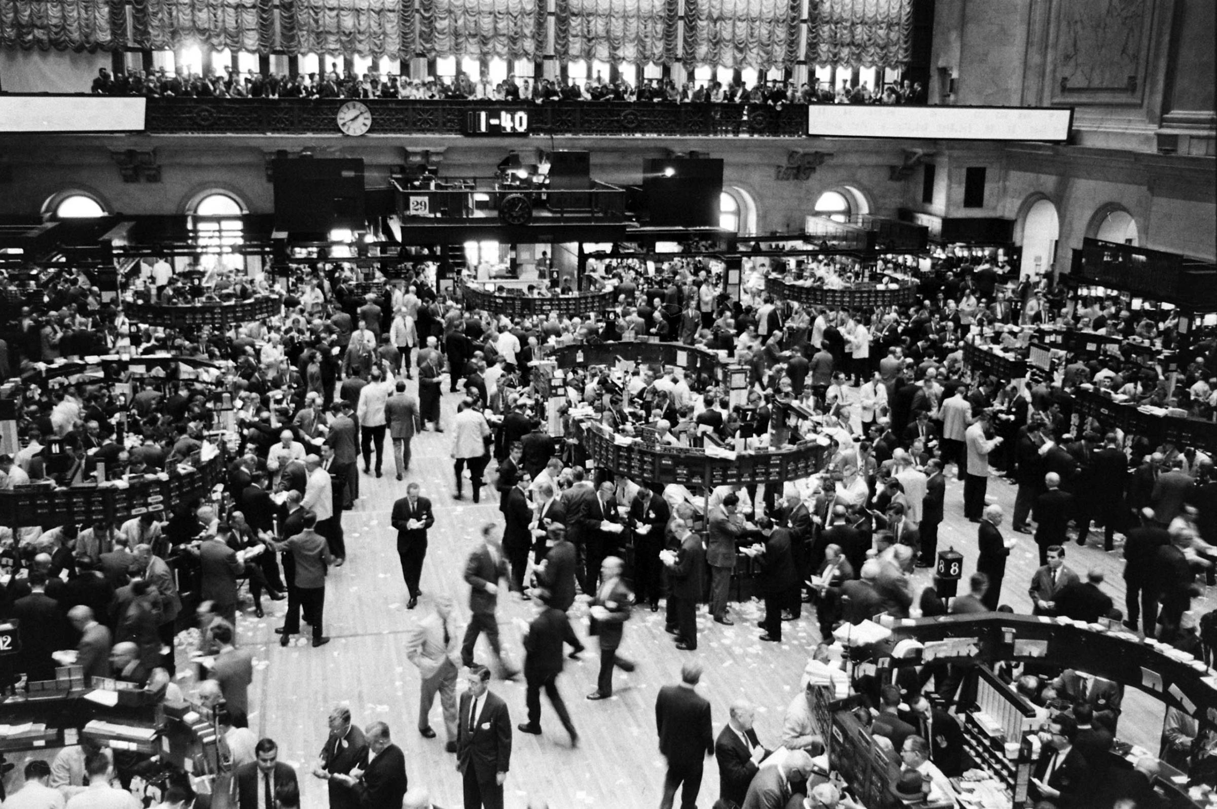 Caption to very similar picture in June 8, 1962, issue of LIFE. "Floor of New York Stock Exchange boils with frenzy of an overheated pot at closing time Tuesday, trying to catch up with transactions which hit nearly 15 million shares for day, highest total since 1929."