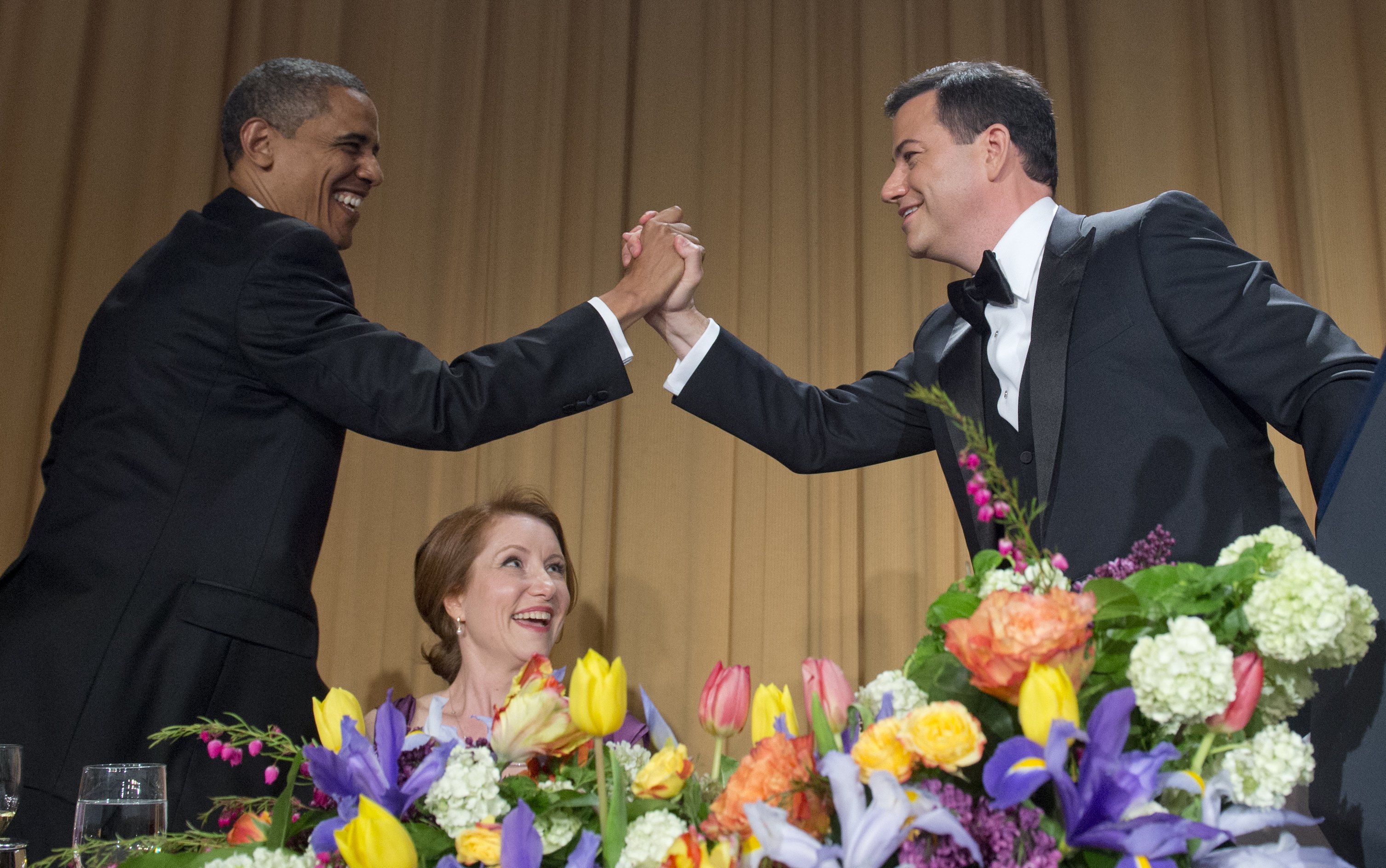 US President Barack Obama high-fives television host Jimmy Kimmel (R) during the White House Correspondents Association Dinner in Washington on April 28, 2012. (Saul Loeb—Getty Images)