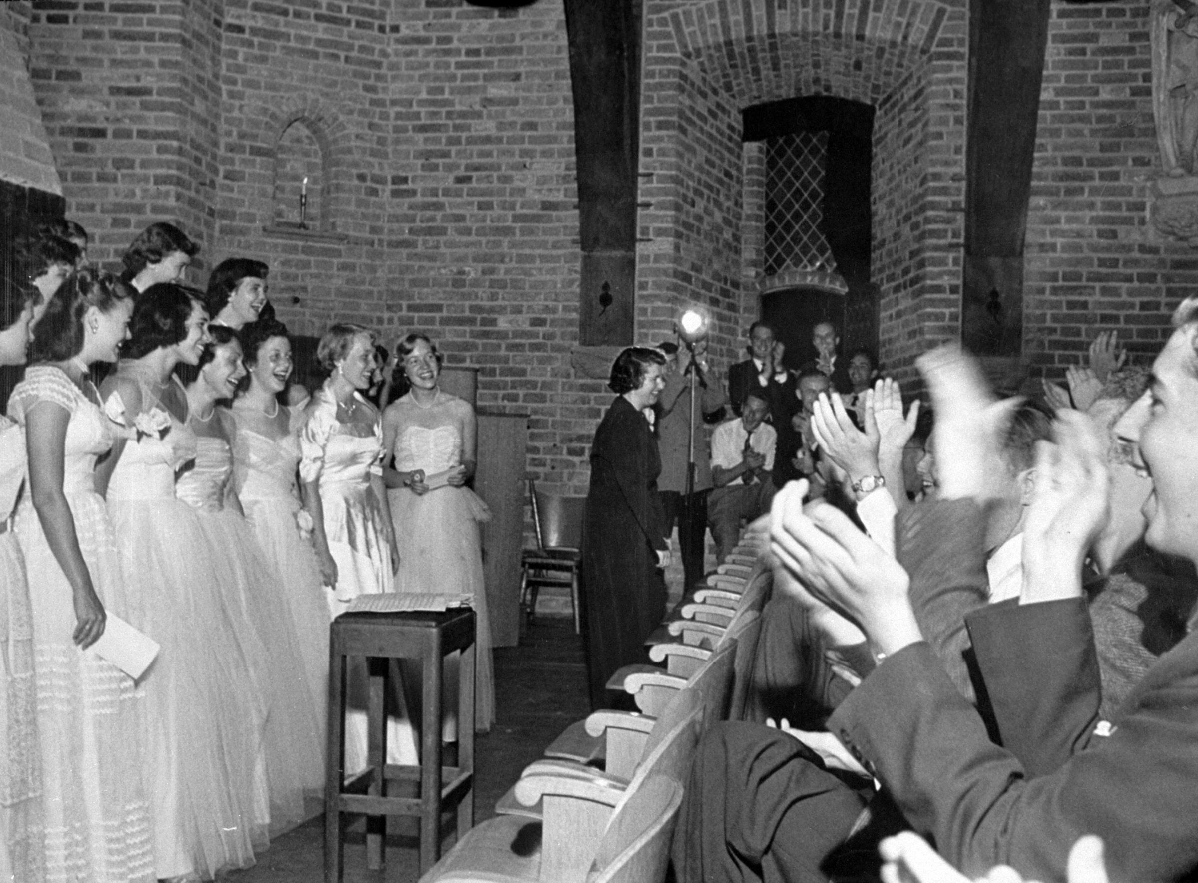 Dressed in white evening gowns, The Smith Singers get a tremendous ovation following a concert in weapons room of Dutch castle at Breukelen, namesake of New York's Brooklyn.